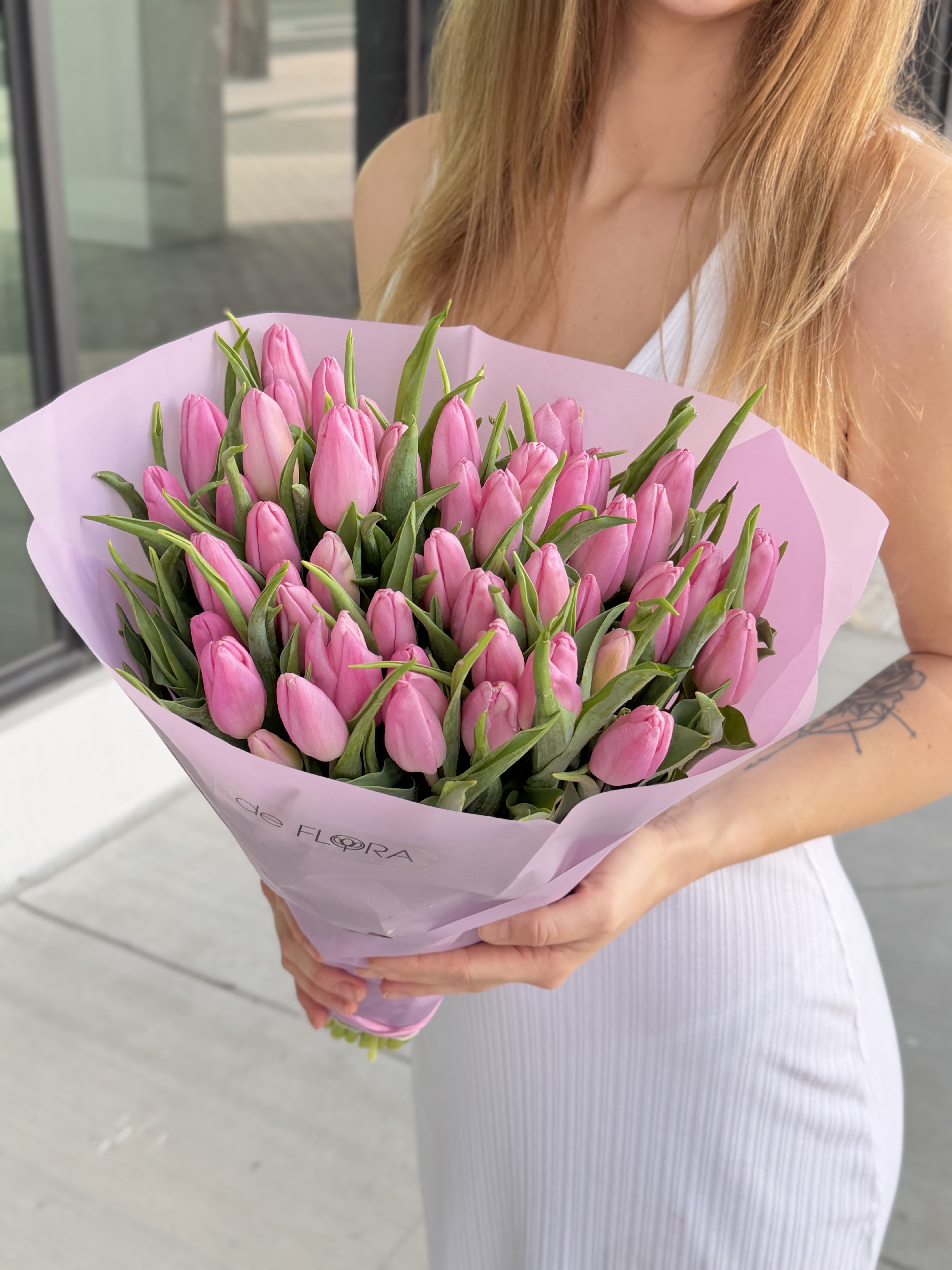 Bouquet of pink tulips wrapped in light pink paper