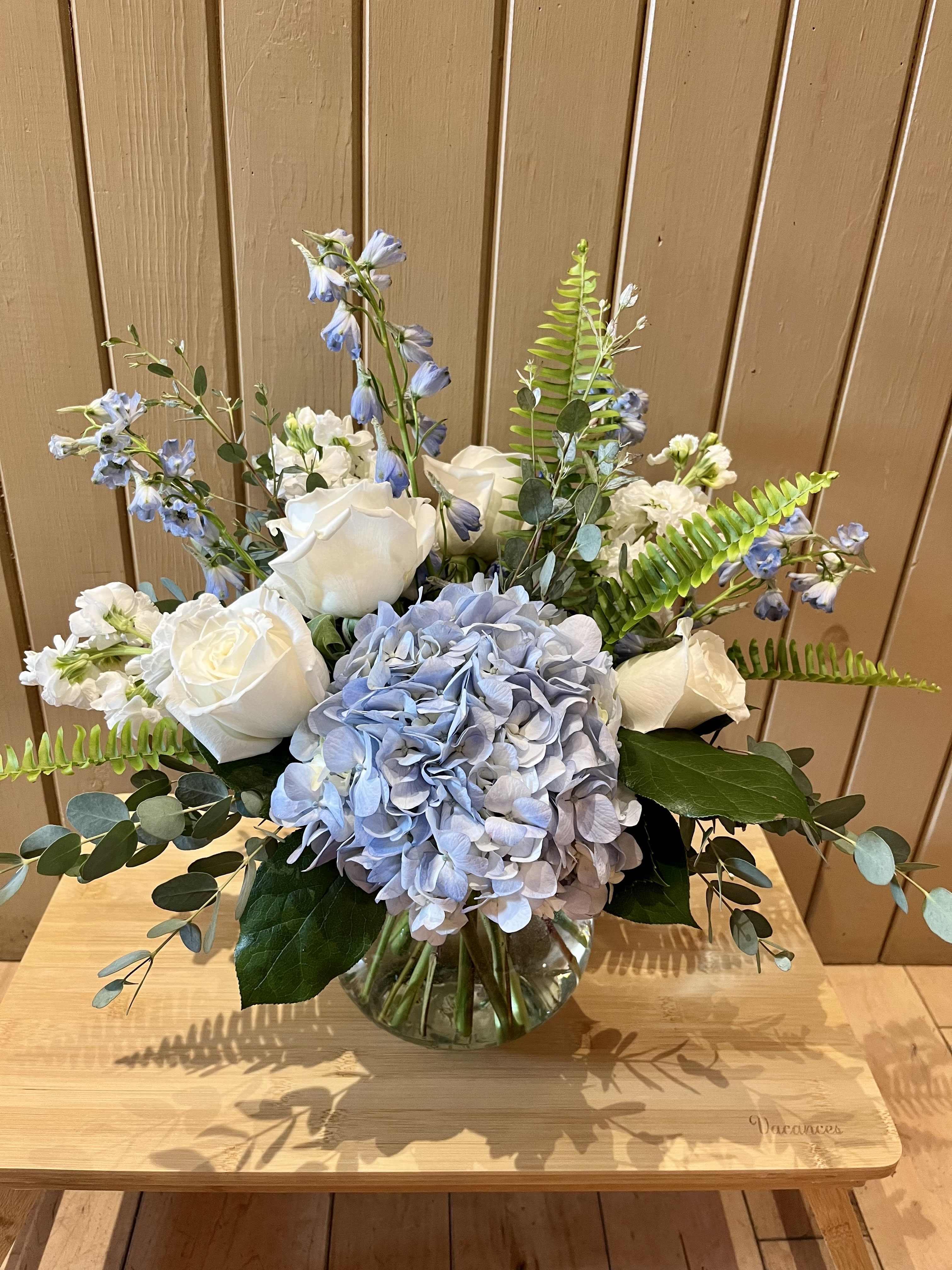 Blue Sky Bouquet - A serene collection of blue and white flowers- including hydrangea, roses, snapdragons and fragrant stock.  Accented with silvery green eucalyptus.