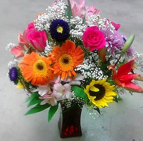 Mixed bouquet of bright gerbera daisies and roses in a vase