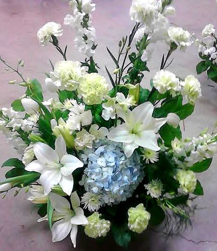 White lilies and hydrangea in a low floral arrangement