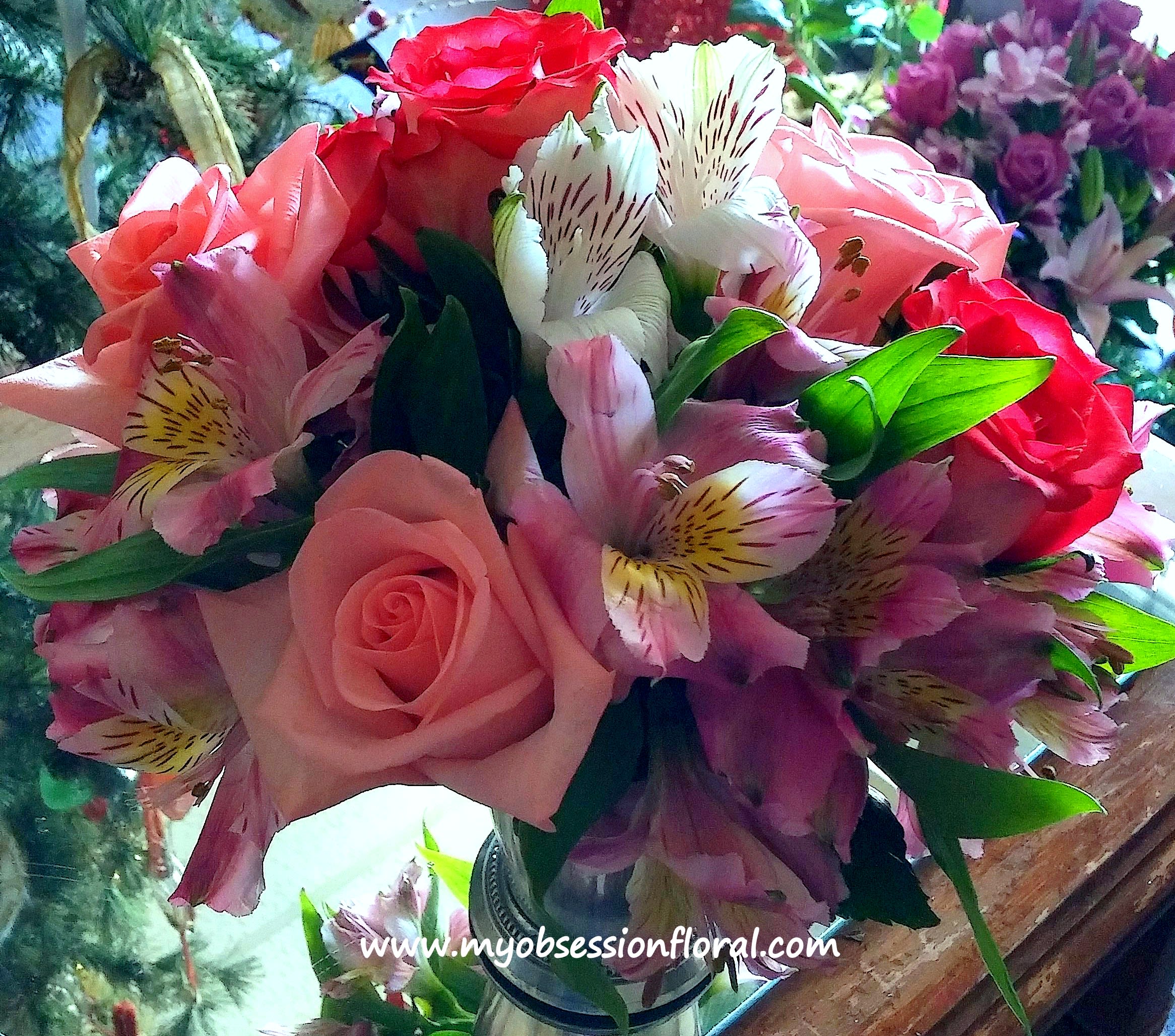Bouquet of pink and red roses with striped alstroemeria