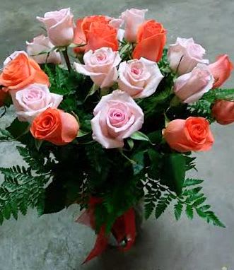 Bouquet of pink and coral roses with fern greenery