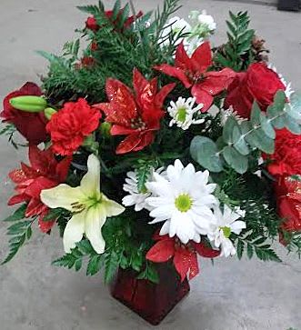 Red and white floral arrangement in a red vase