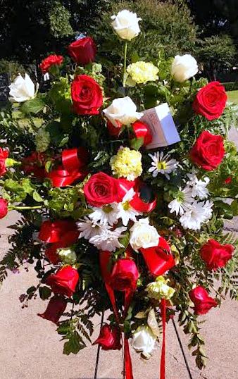 Standing floral spray with red and white roses and daisies