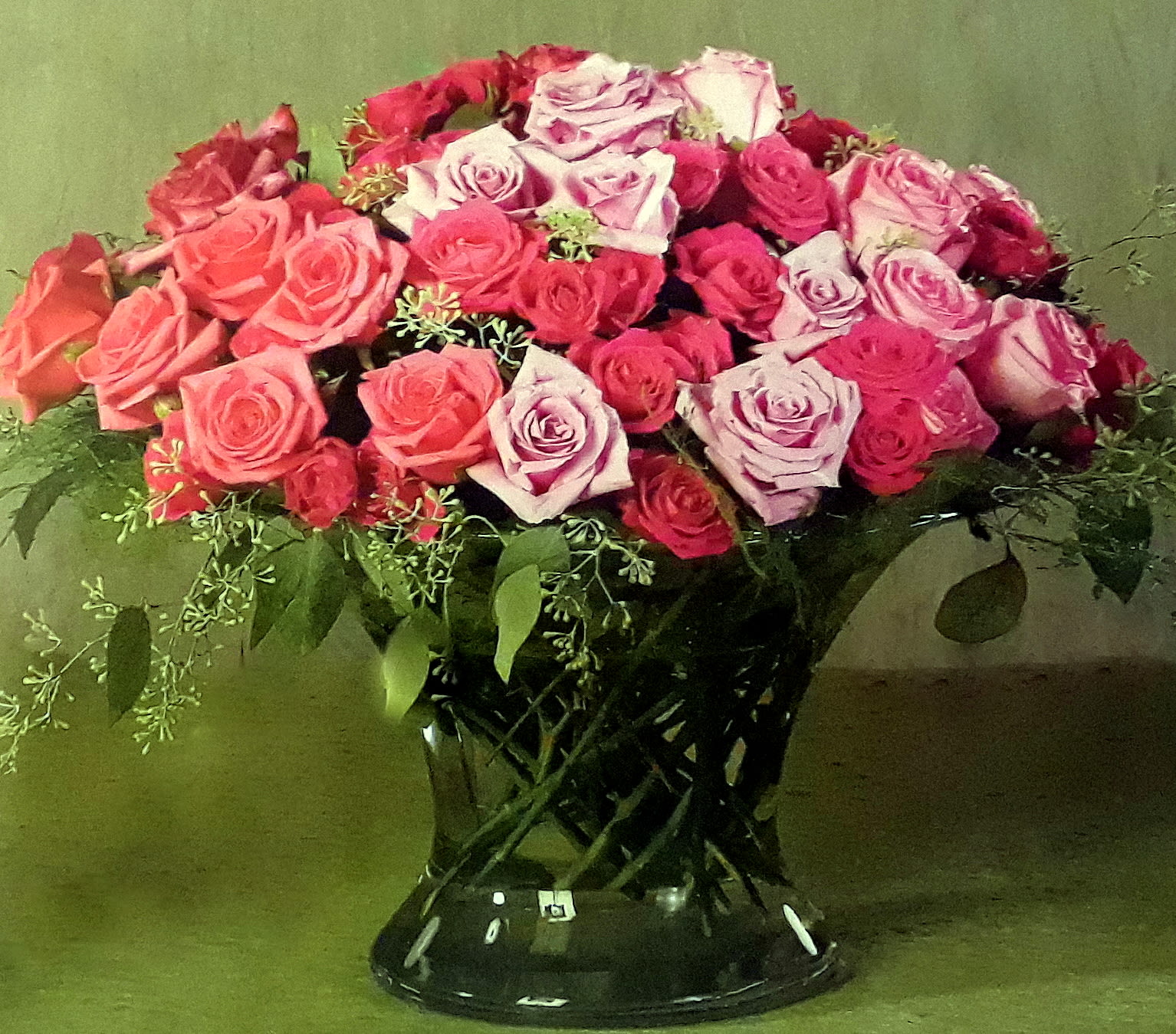 Bouquet of pink and lavender roses in a black vase