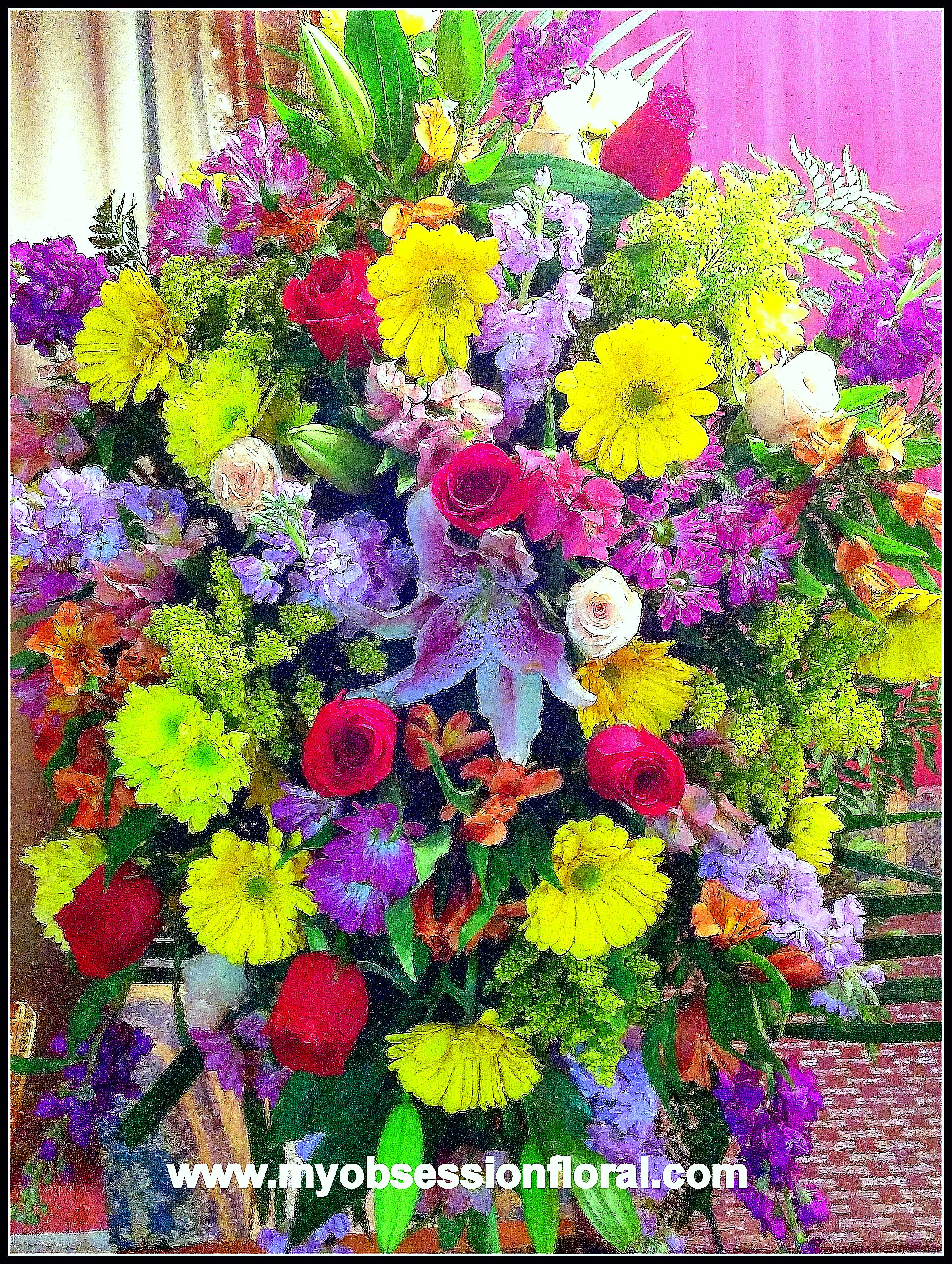 Large mixed bouquet with roses, lilies, and bright daisy-like flowers