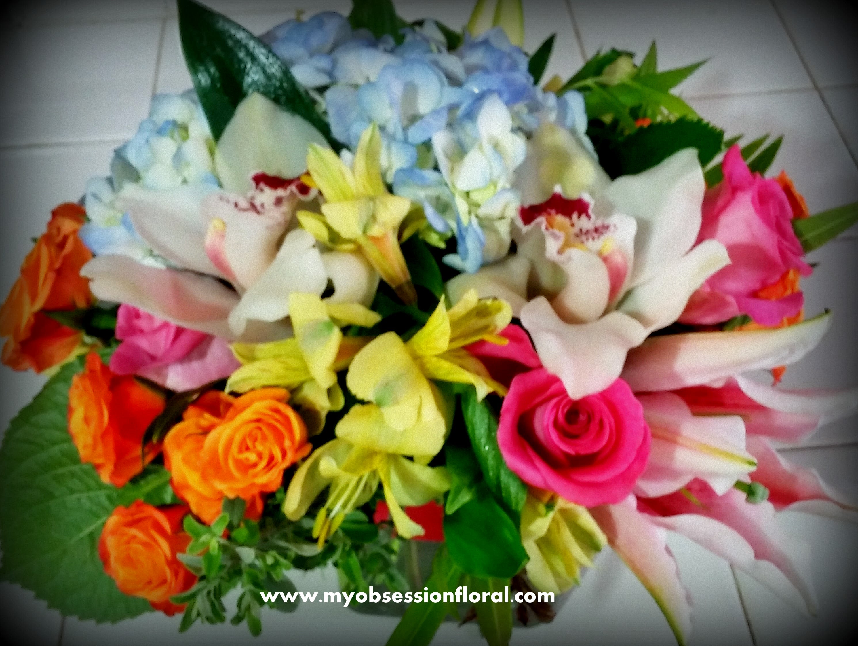 Mixed bouquet with roses, lilies, hydrangeas, and orchids