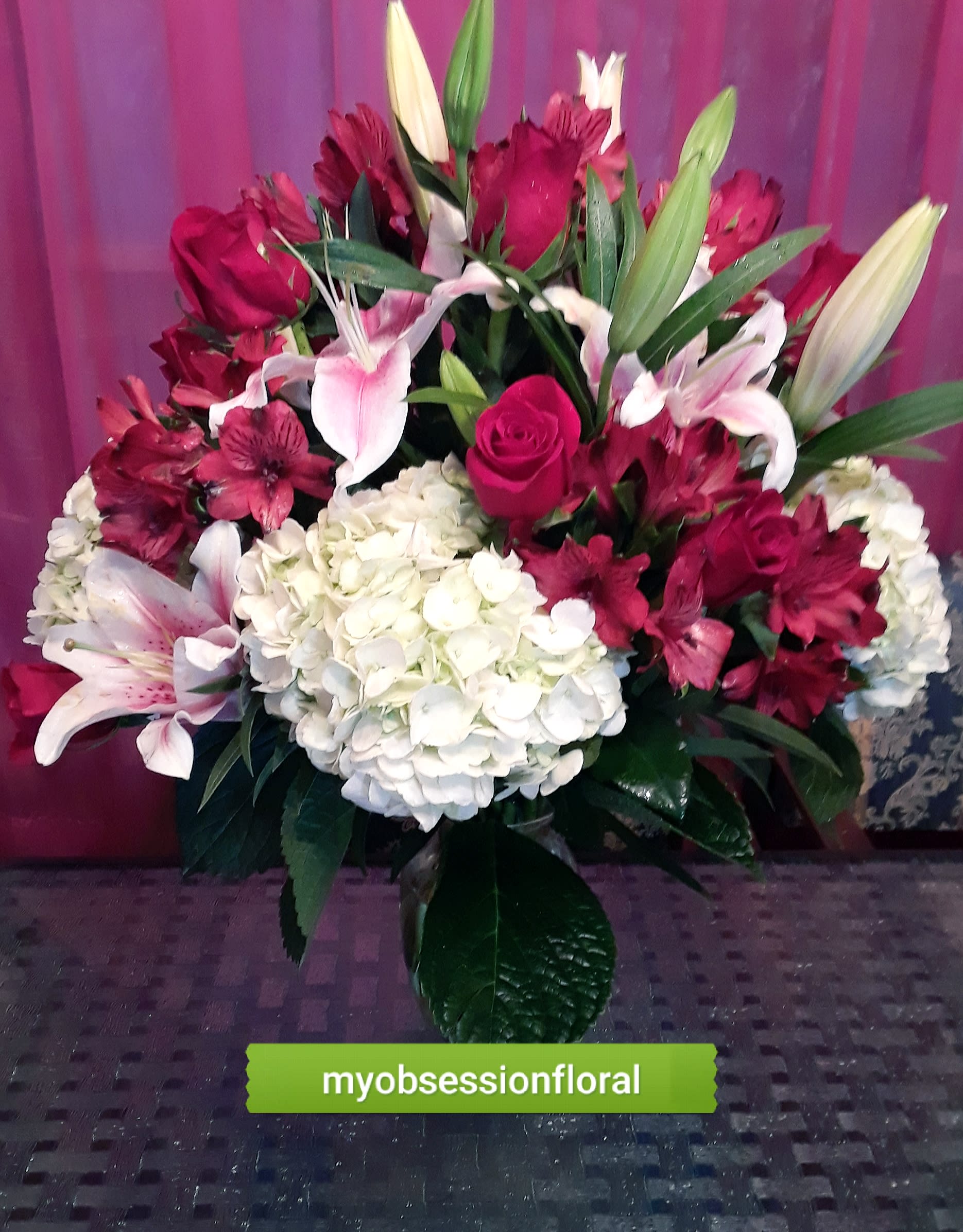 Bouquet of red roses, white lilies, and white hydrangea