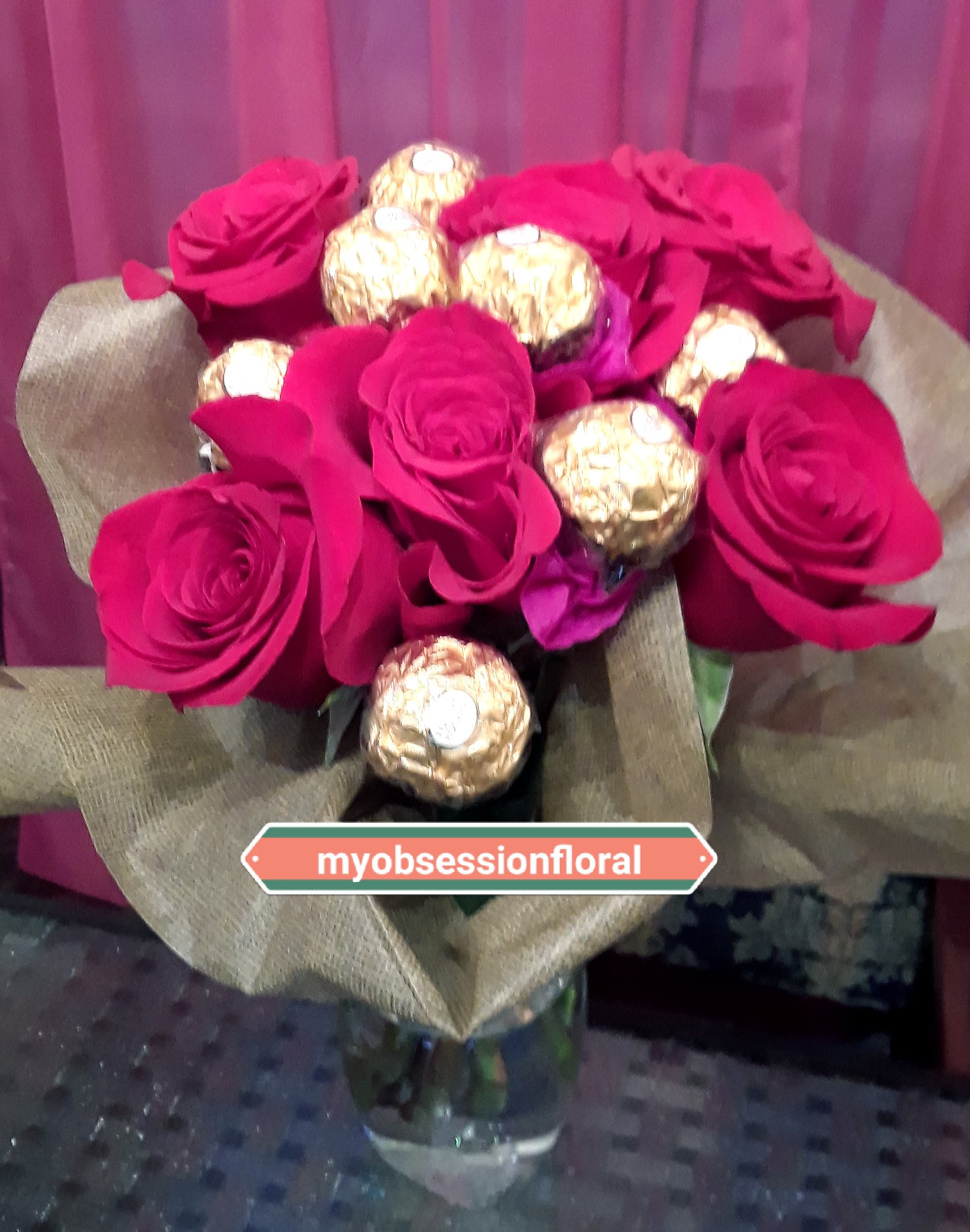 Bouquet of hot pink roses with gold-wrapped chocolates in burlap wrap