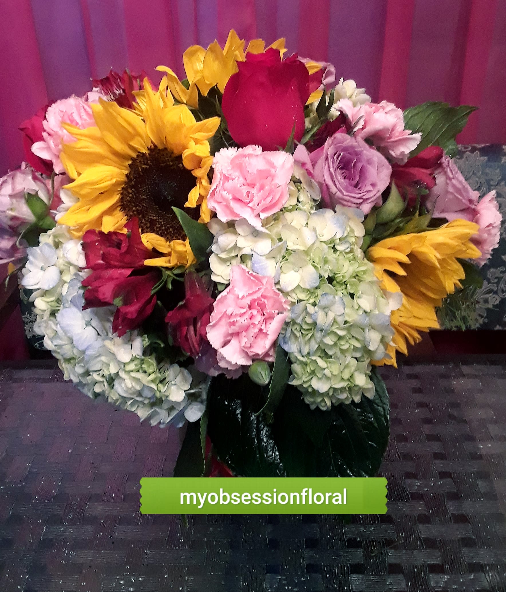 Mixed bouquet with sunflowers, roses, hydrangeas, and carnations