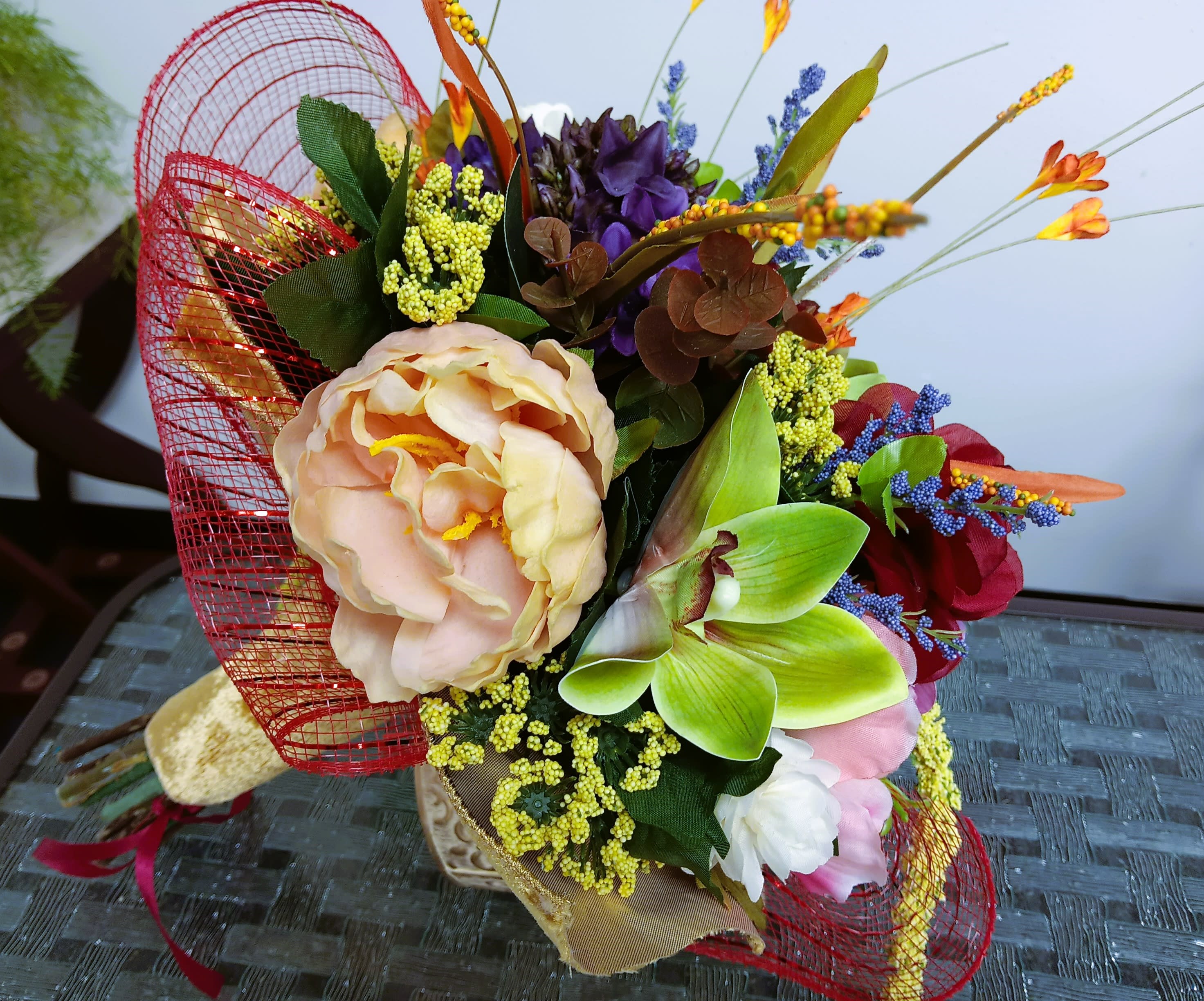 Colorful bouquet with large peach, purple, and green blooms