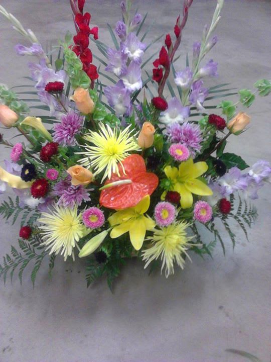 Colorful mixed flower arrangement with lilies, roses, and chrysanthemums