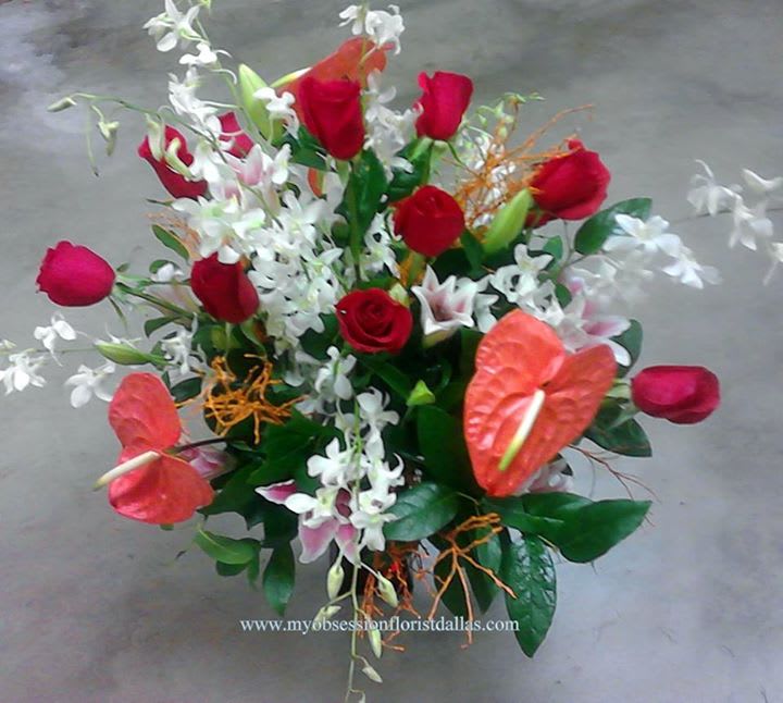 Bouquet of red roses, white orchids, and red anthuriums