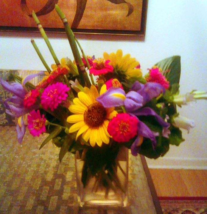 Bright mixed bouquet with yellow daisies, pink blooms, and purple flowers
