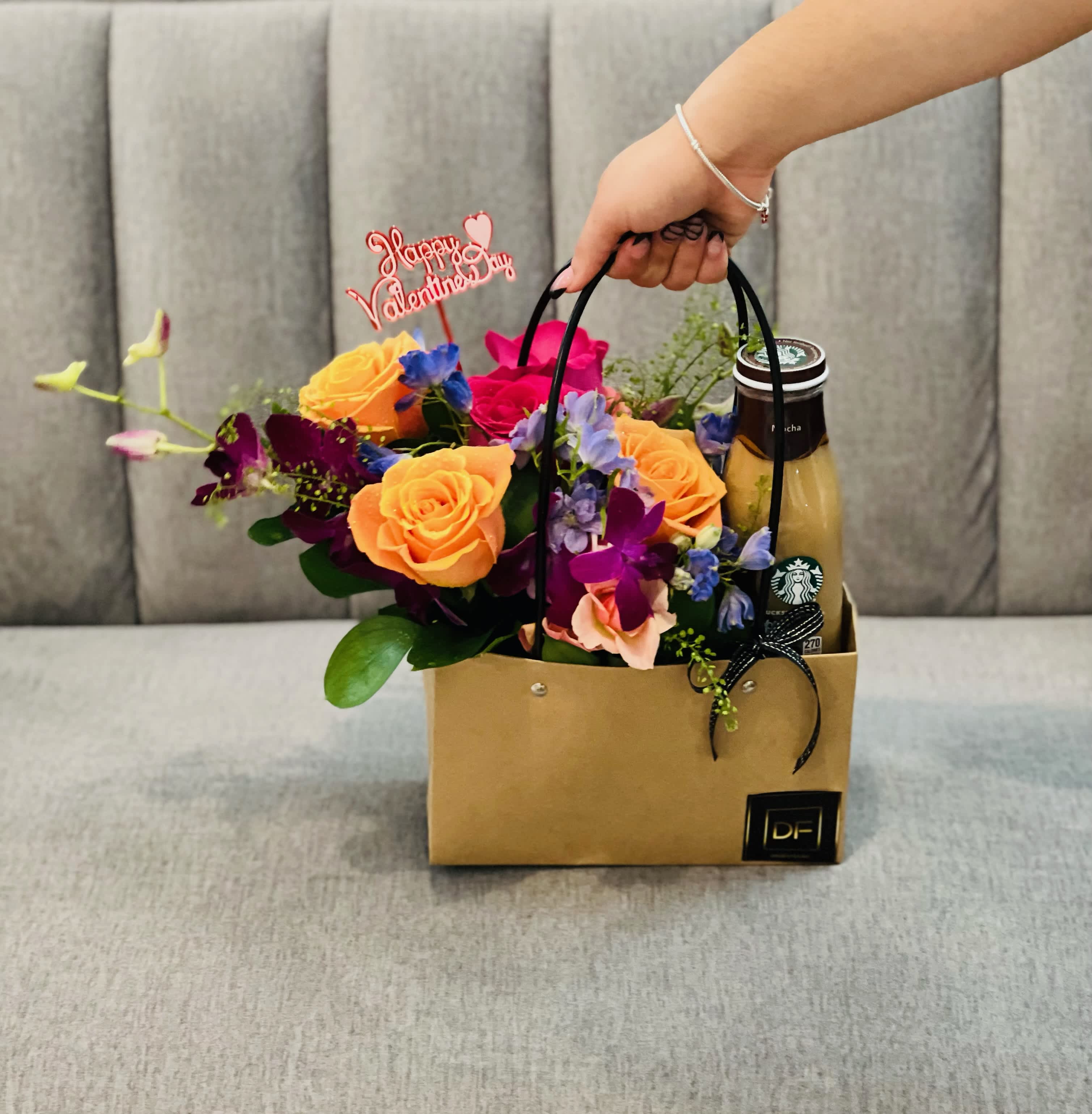 Flower gift bag with roses and a drink bottle