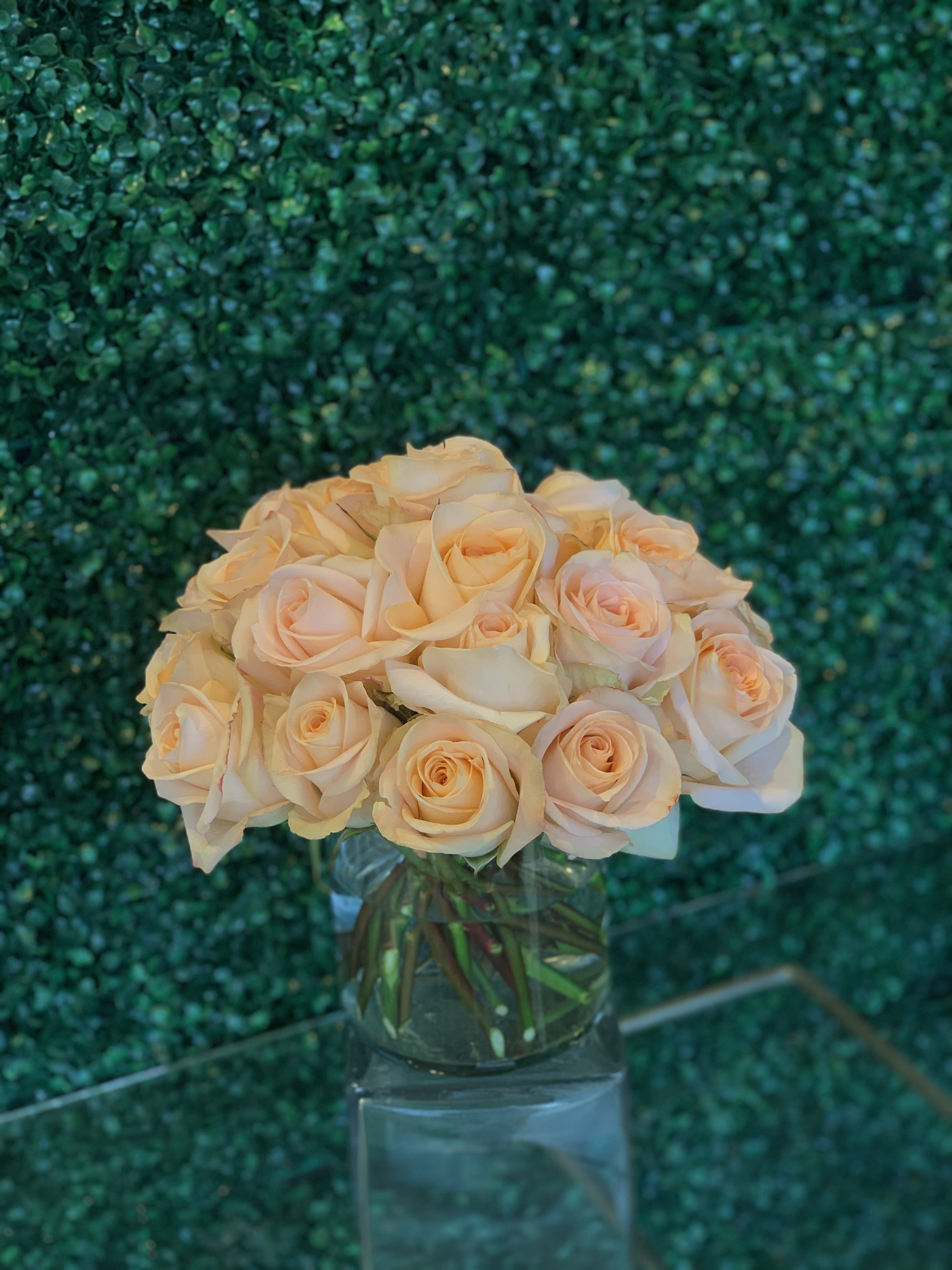 Bouquet of pale peach roses in a clear glass vase