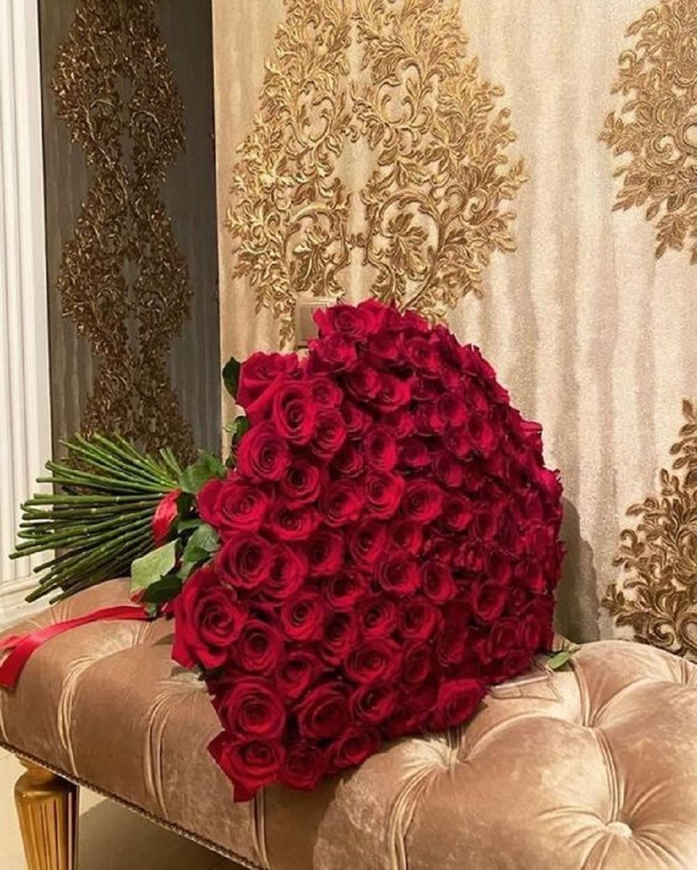 Large bouquet of red roses with long stems tied together