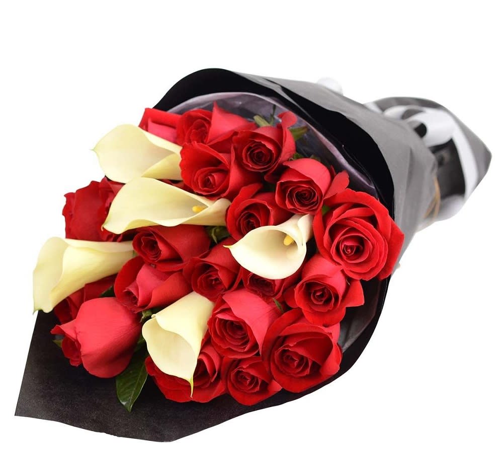 Bouquet of red roses and white calla lilies wrapped in black paper