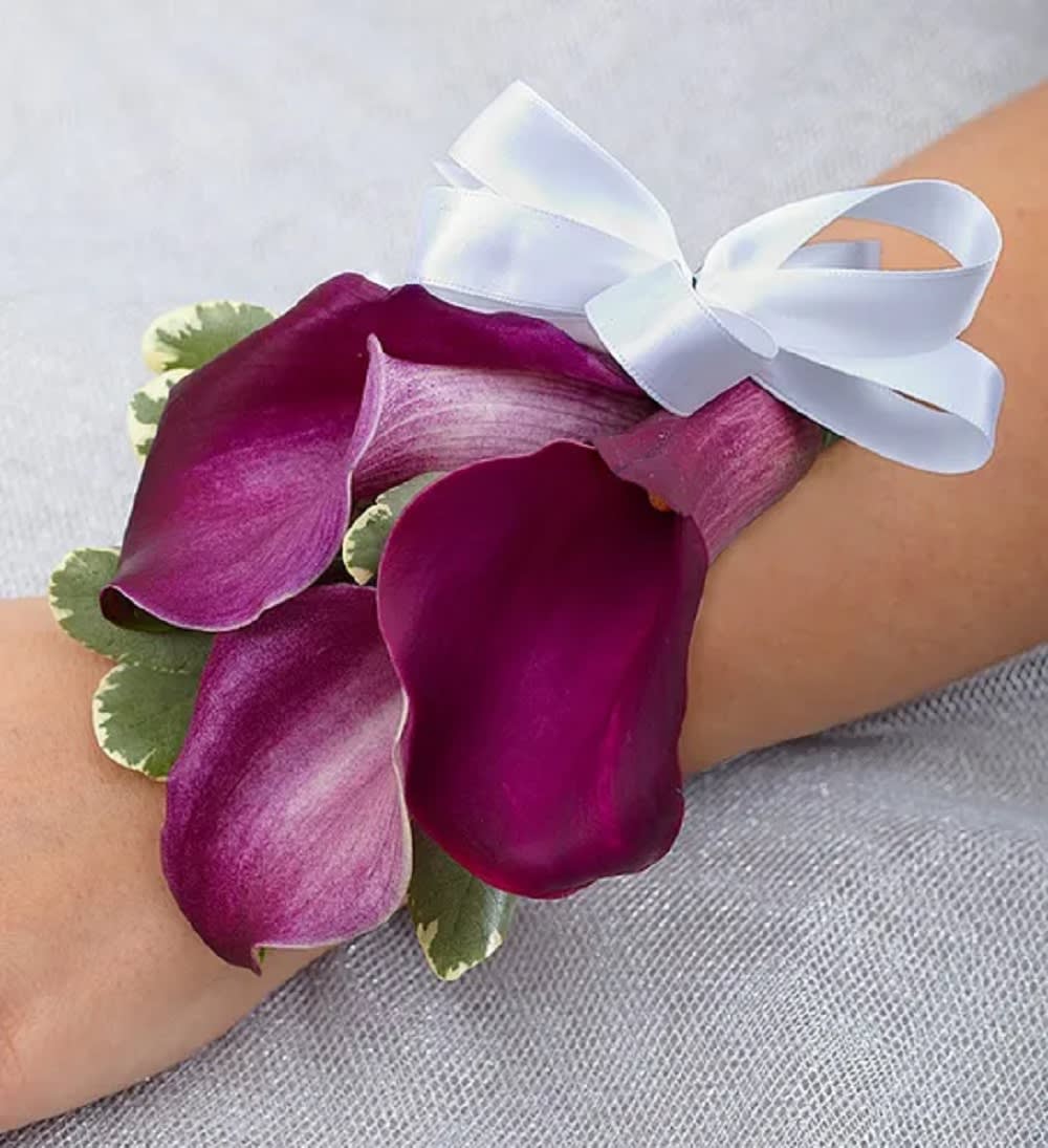 Purple calla lily wrist corsage with a white ribbon