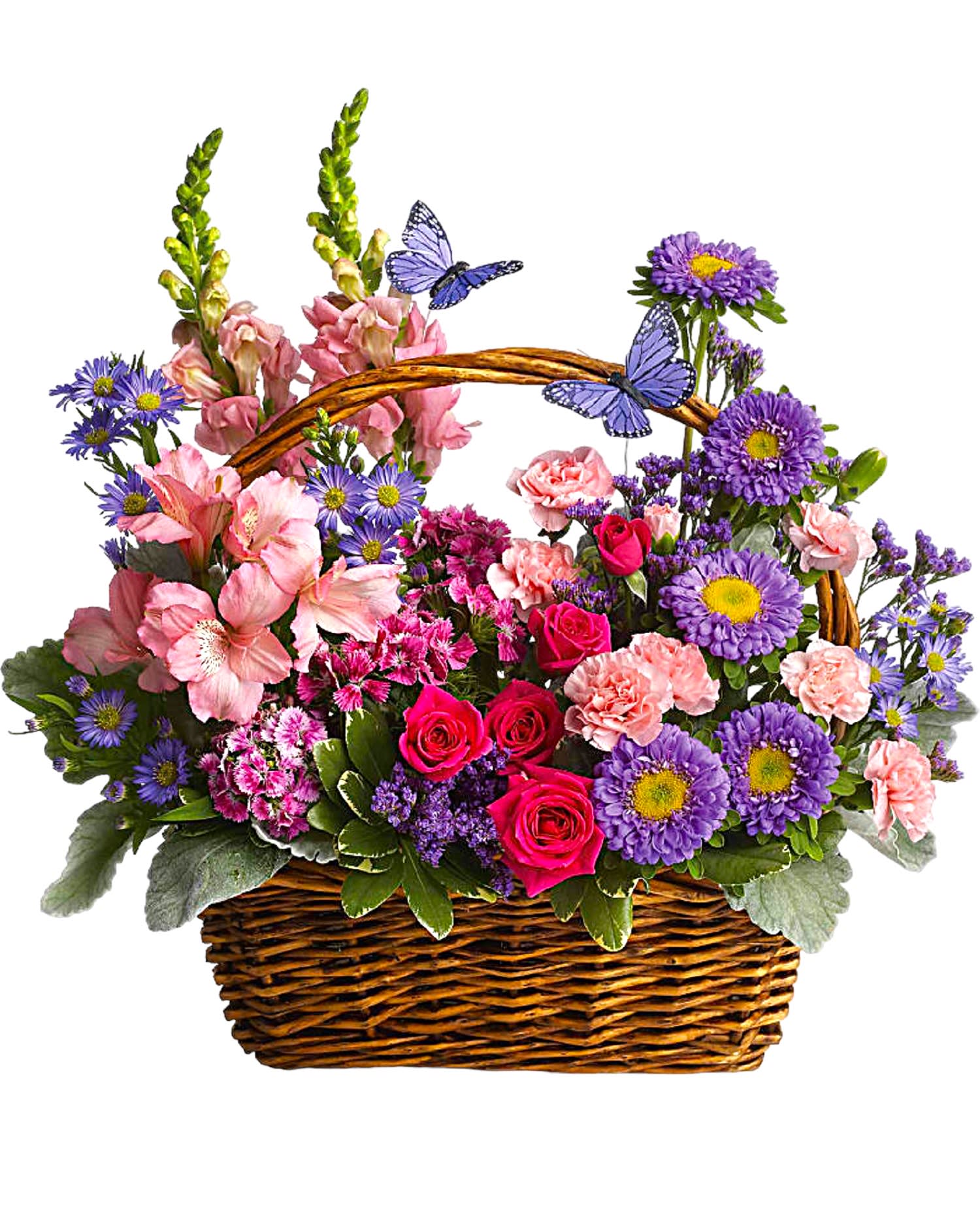 Mixed pink and purple flowers in a wicker basket with butterfly picks