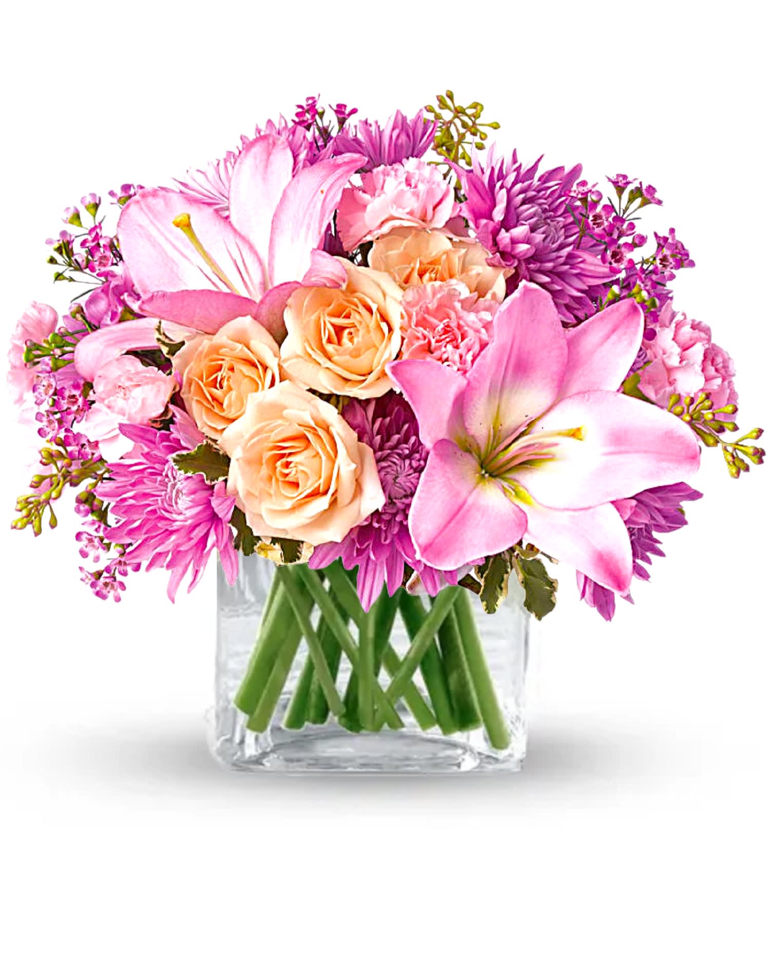 Pink and peach flowers arranged in a clear glass vase