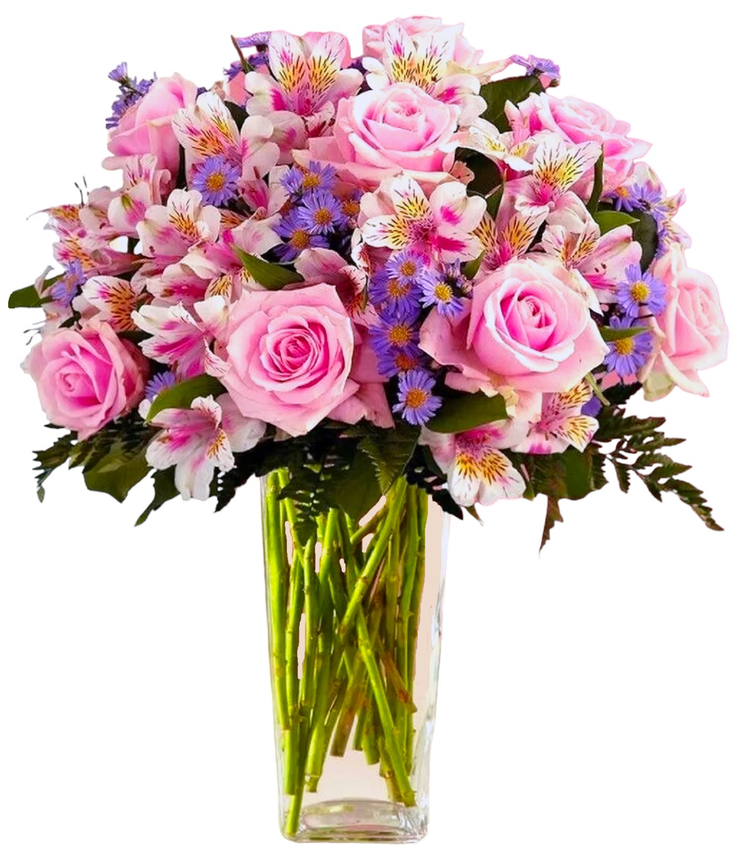 Pink roses and mixed purple flowers in a clear glass vase