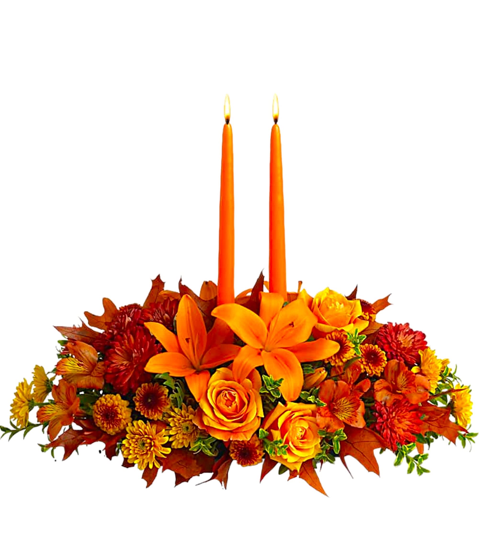 Orange floral centerpiece with two lit taper candles