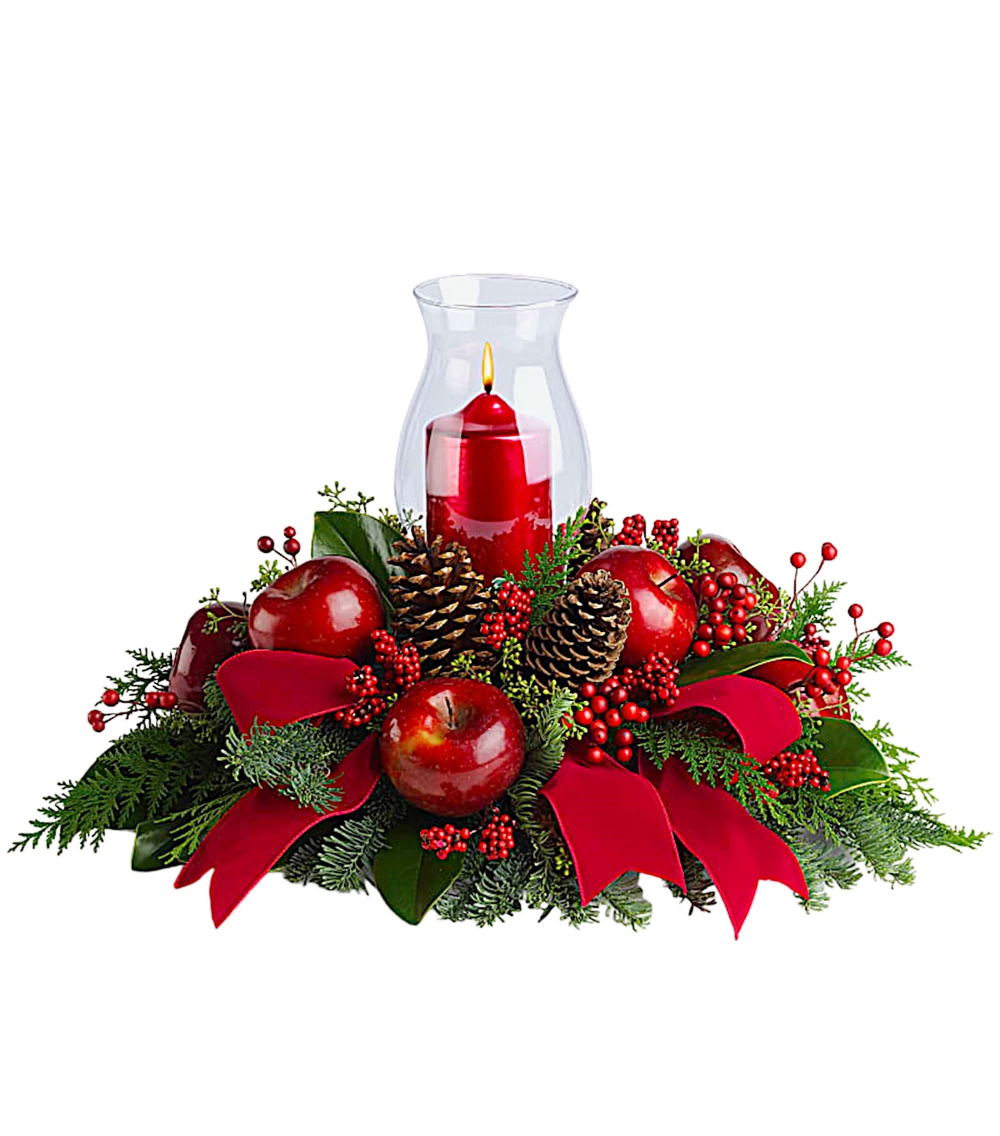 Red candle in a glass hurricane surrounded by apples, pinecones, and ribbon