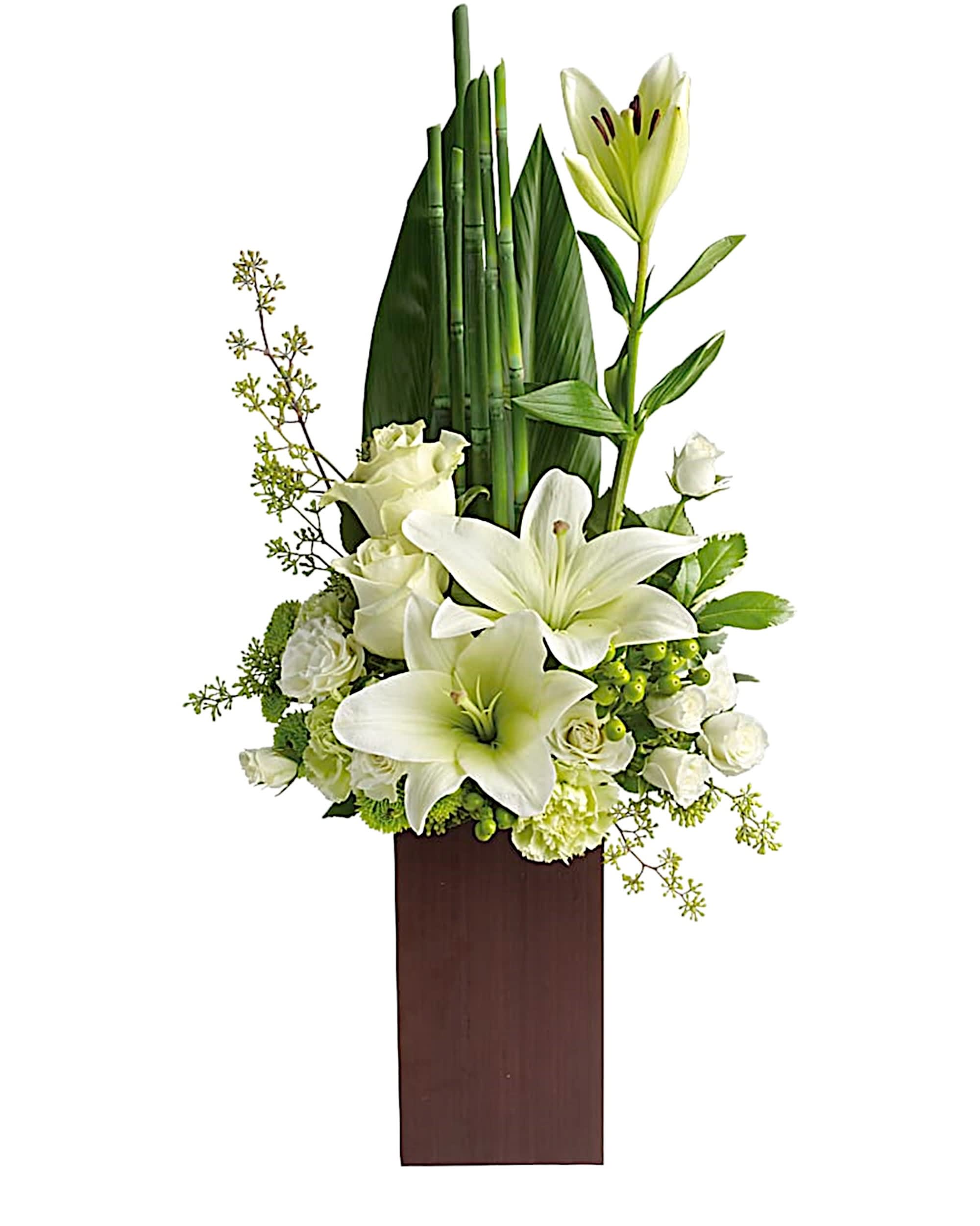 White lilies and roses in a tall wooden vase arrangement
