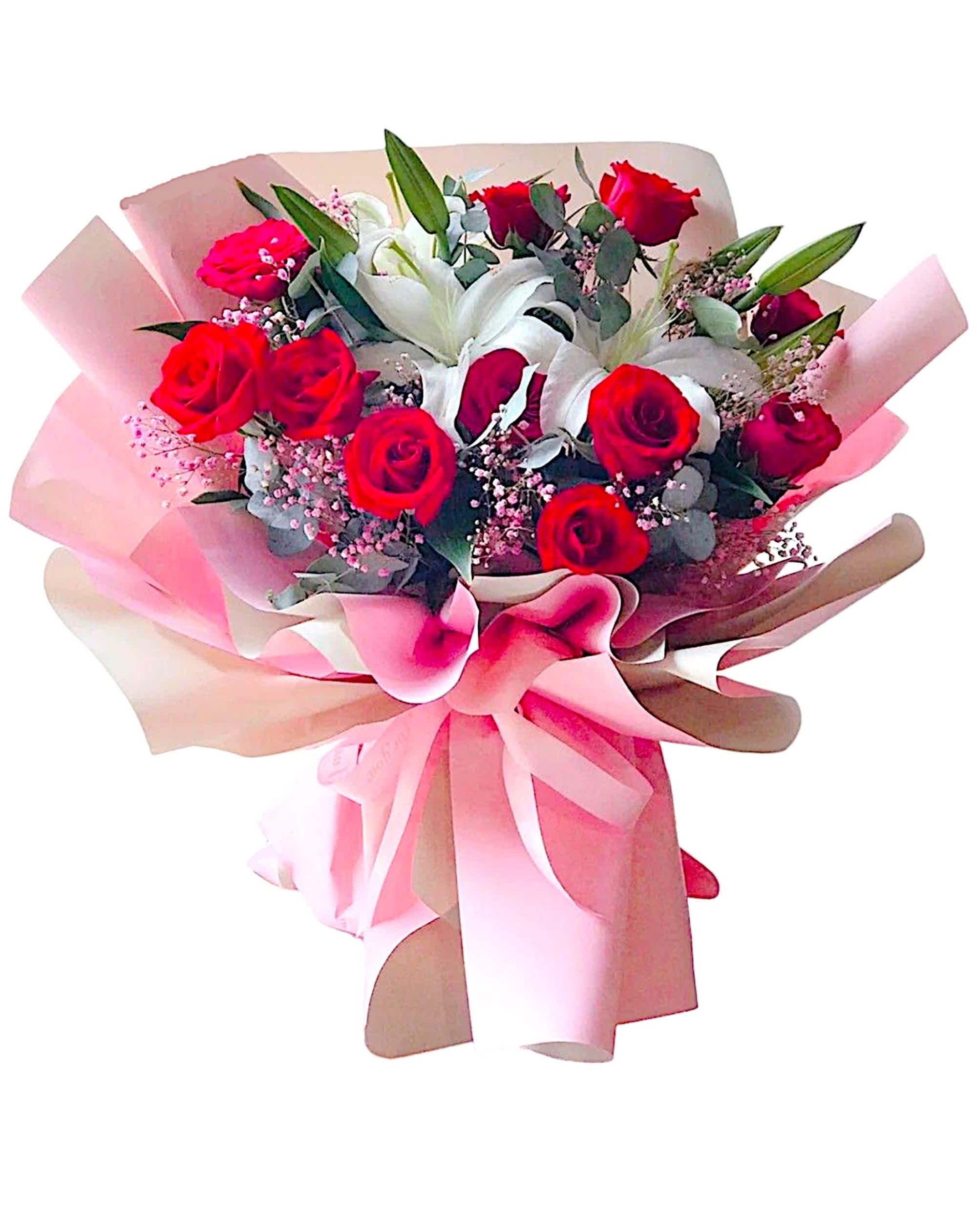 Bouquet of red roses and white lilies wrapped in pink paper