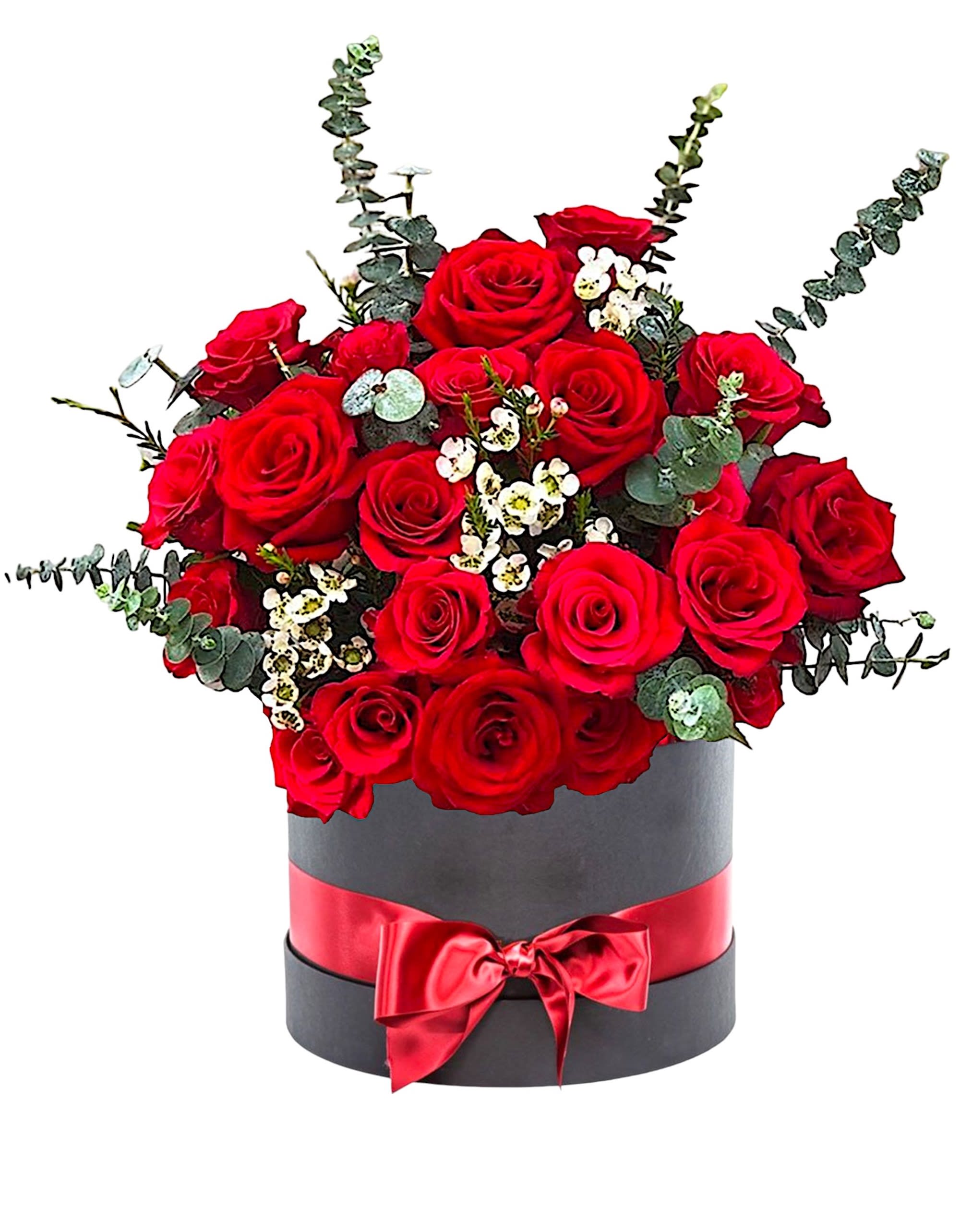 Red roses arranged in a black hatbox with a red ribbon