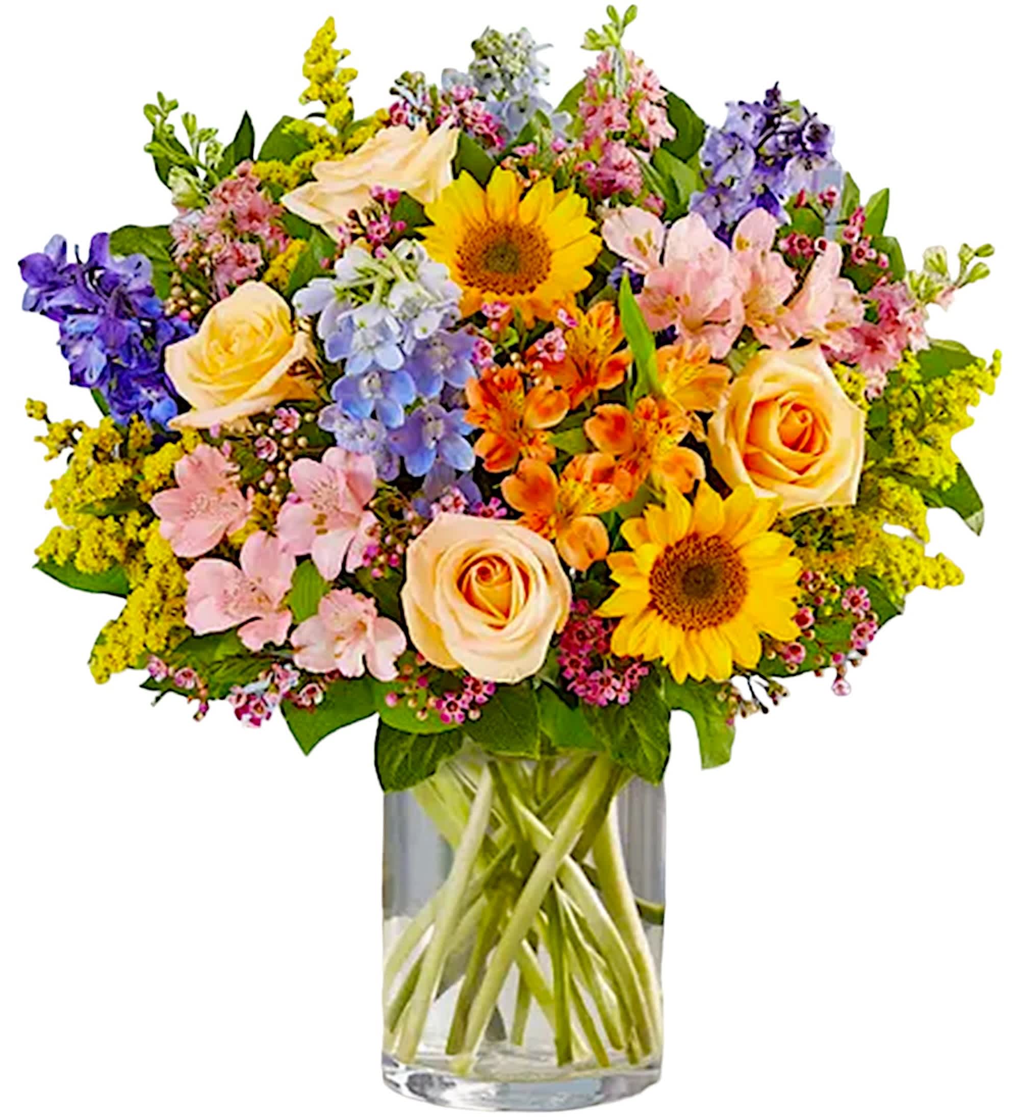 Colorful mixed bouquet with roses, sunflowers, and delphinium in a glass vase