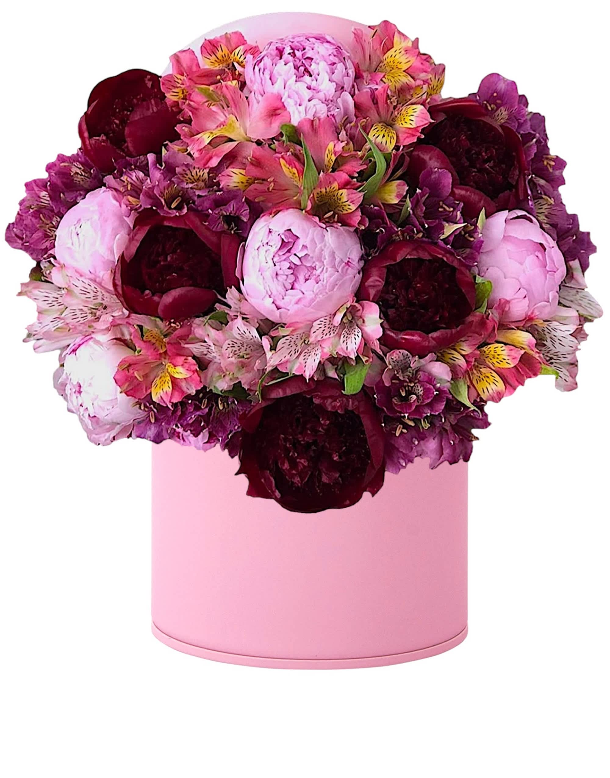 Pink and burgundy flower arrangement in a round pink box