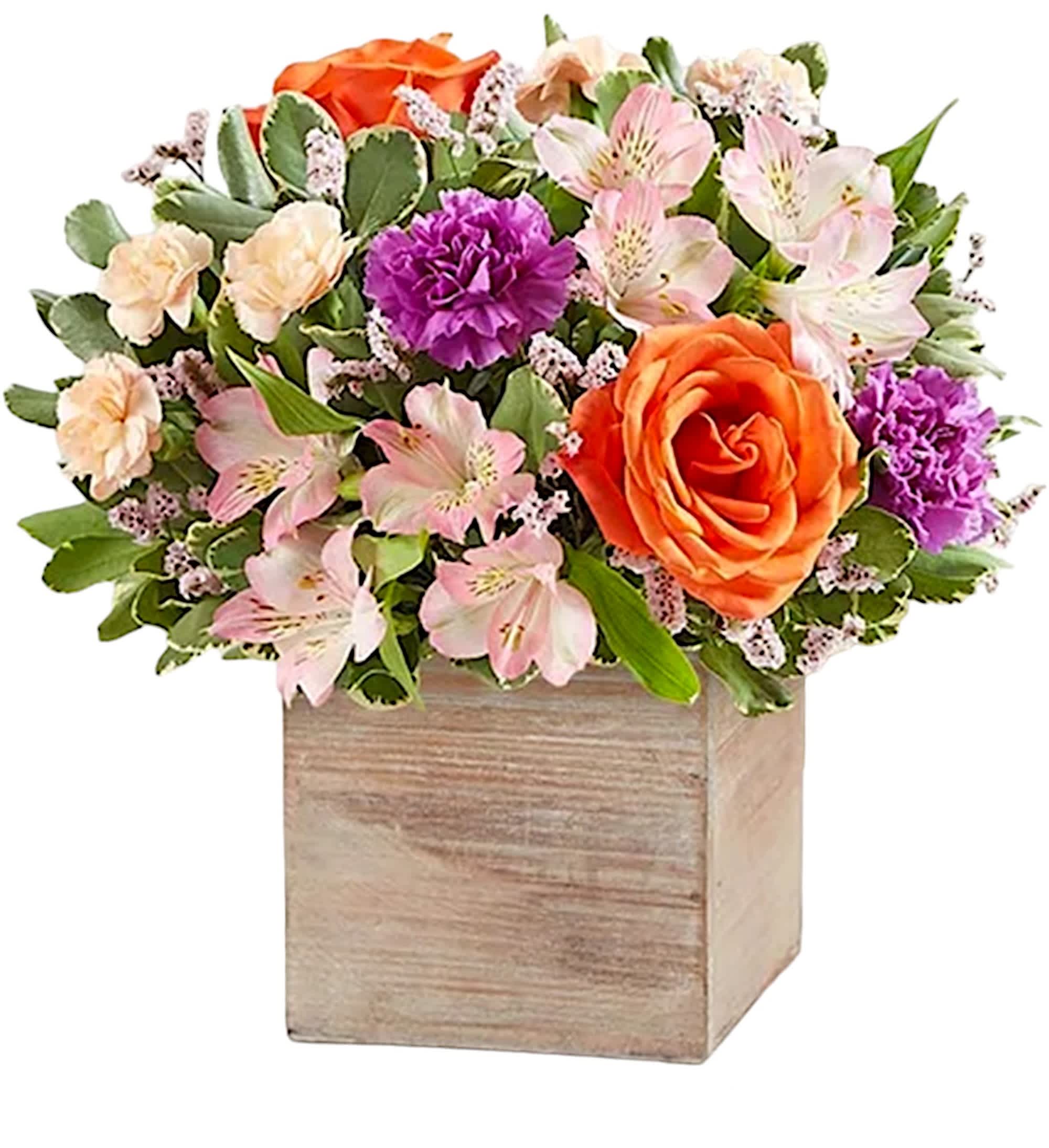Mixed bouquet in a wooden box with orange and pink flowers