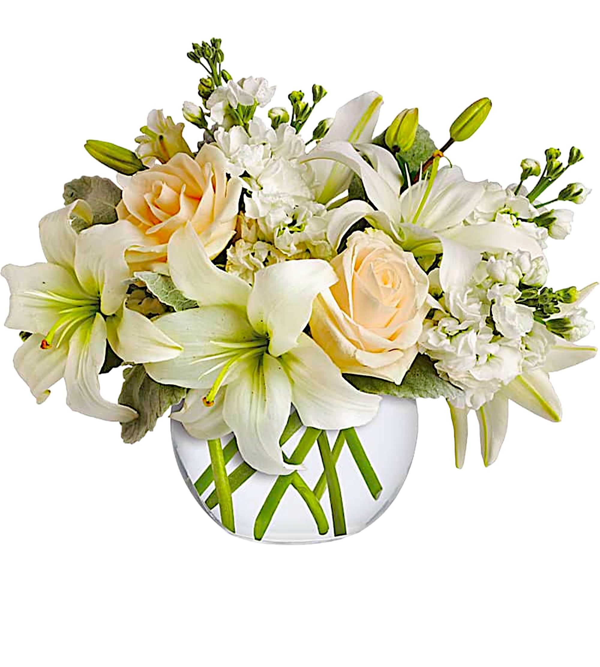 White lilies and pale peach roses in a clear glass vase