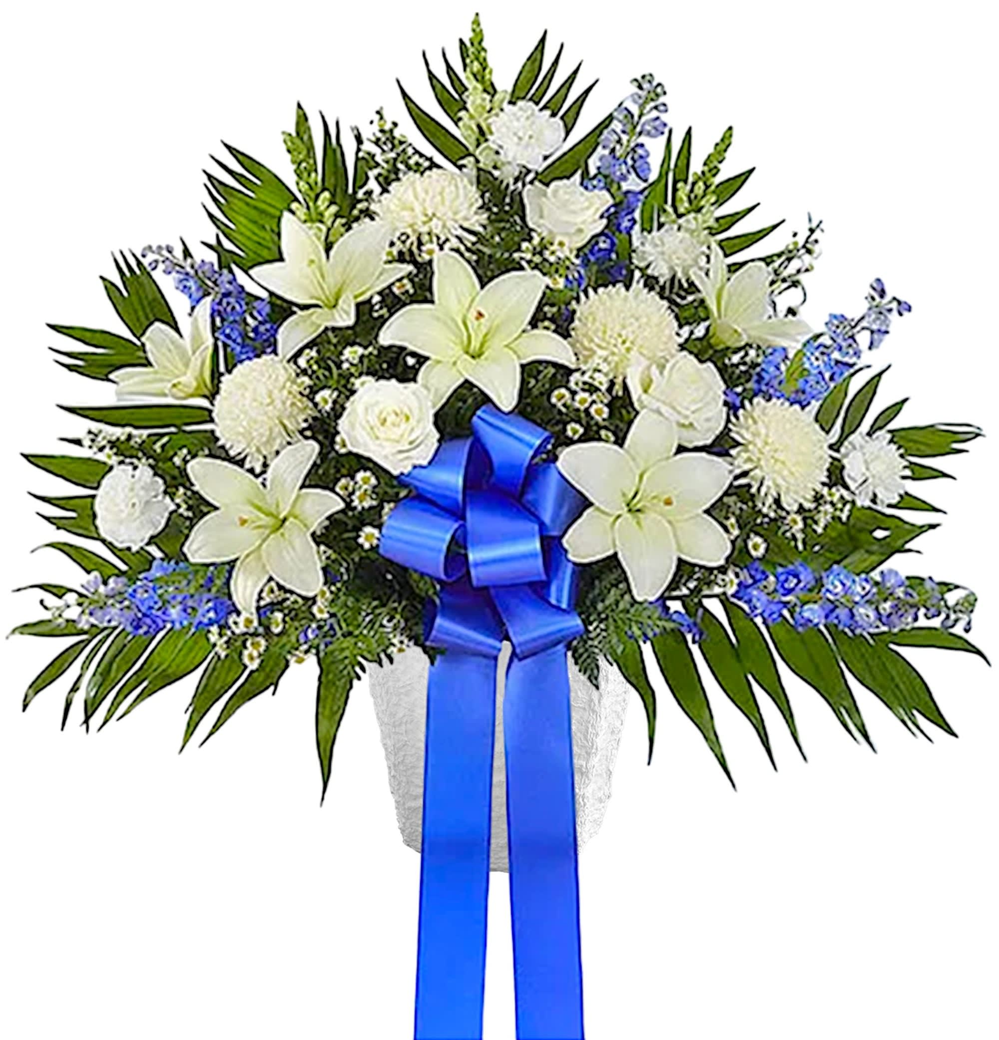 White lilies and chrysanthemums with blue ribbon in a vase