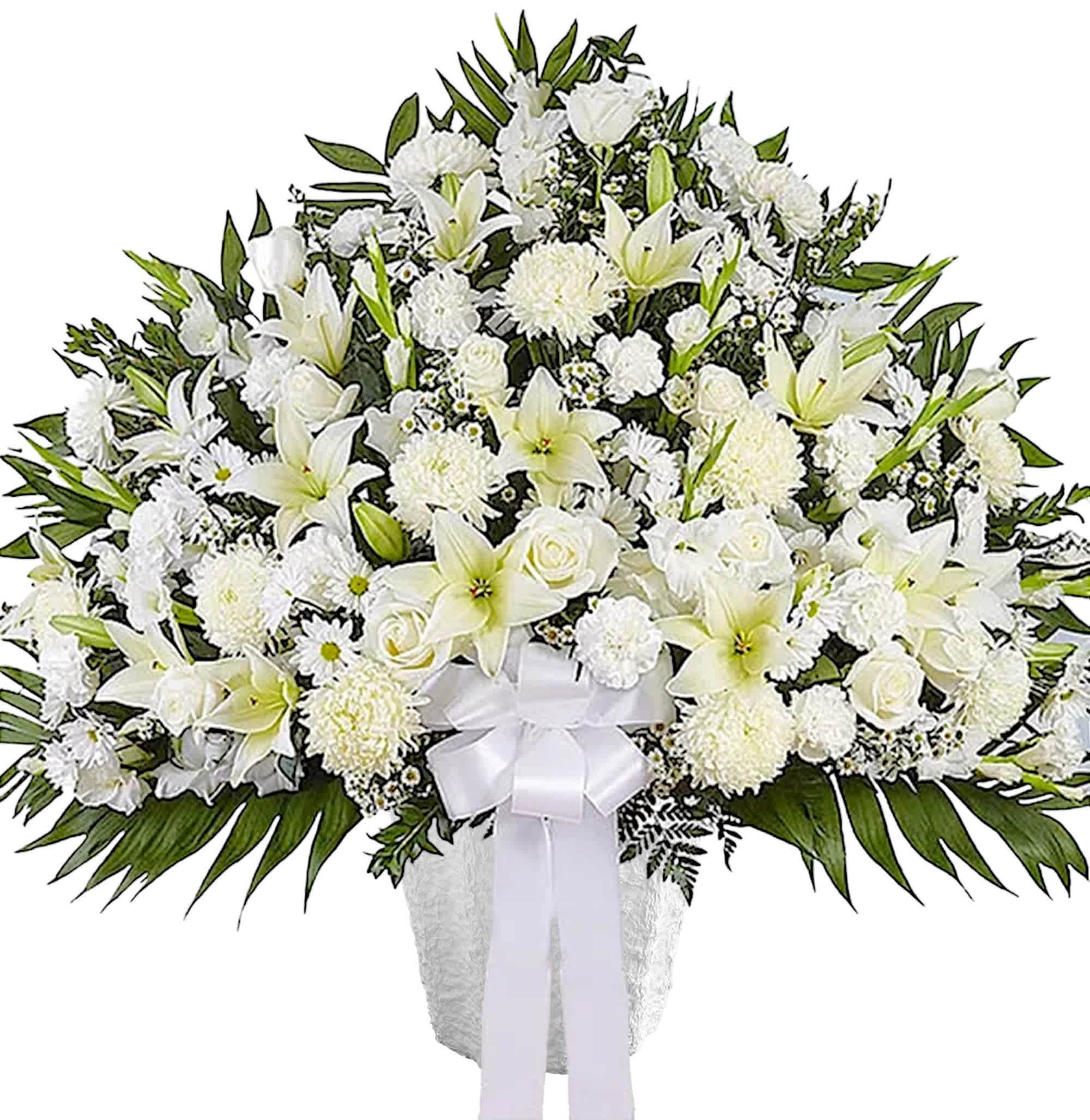White funeral spray with lilies, roses, and chrysanthemums in a vase