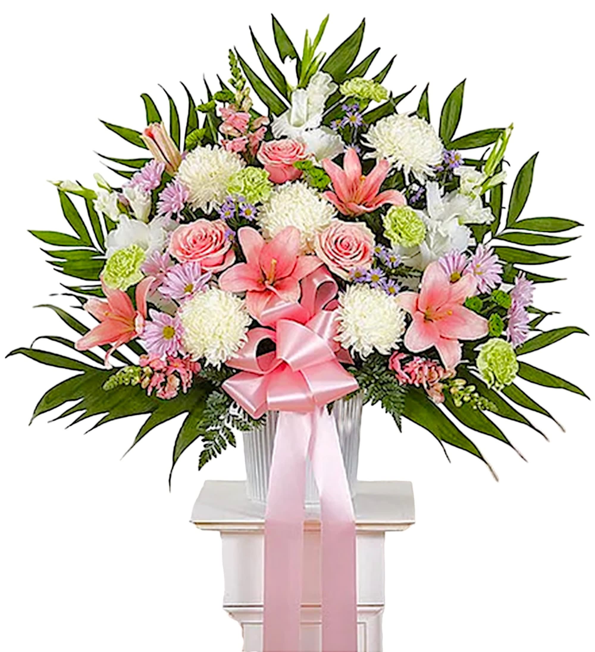 Pink and white floral spray in a vase with a pink ribbon