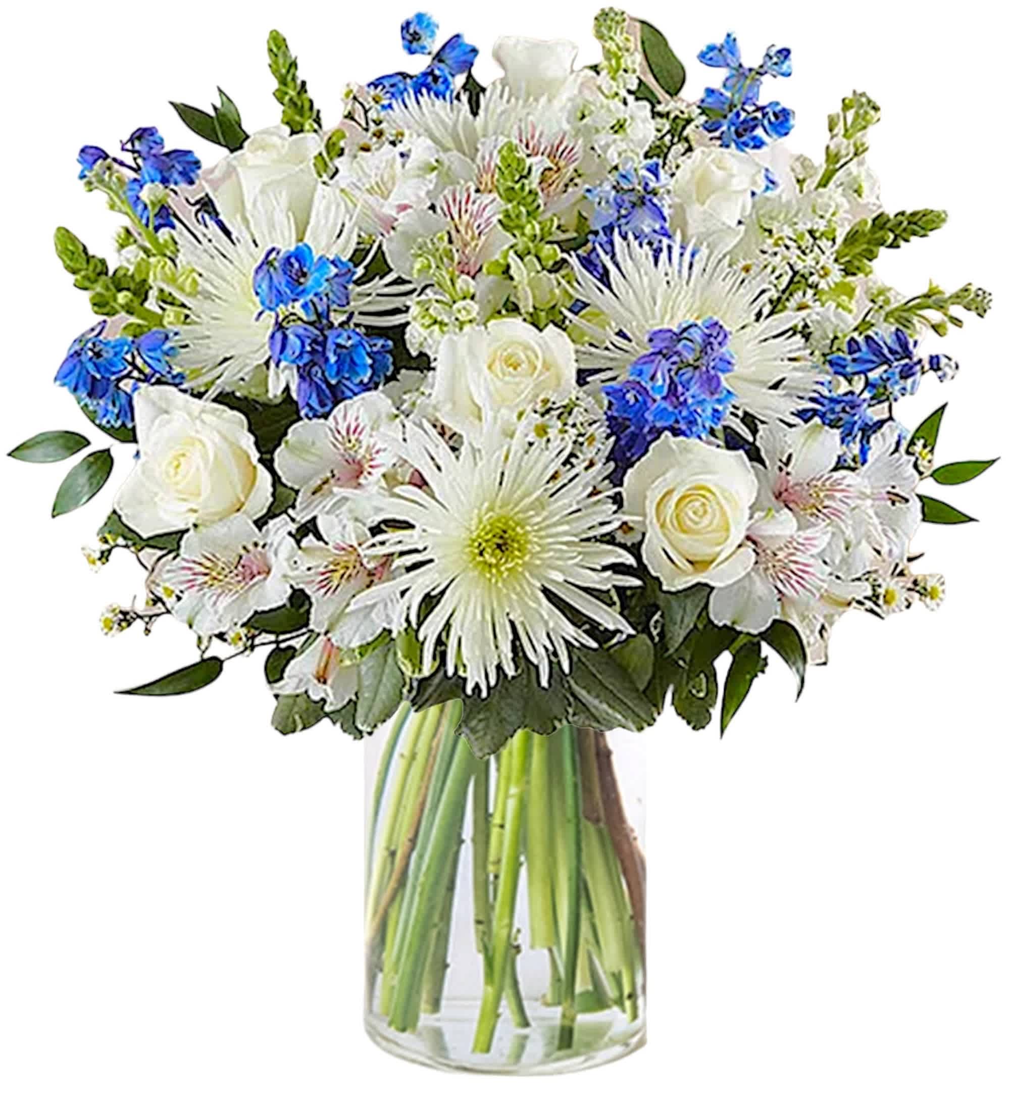 White and blue mixed bouquet in a clear glass vase