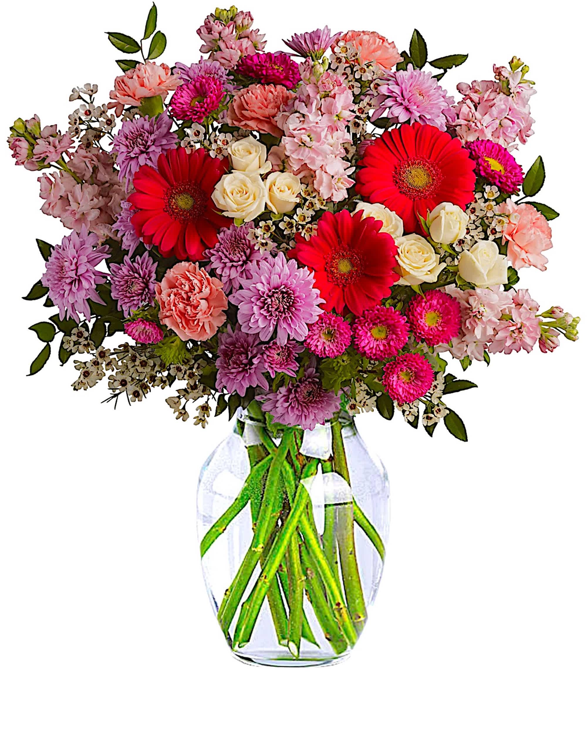 Mixed pink and red flowers in a clear glass vase