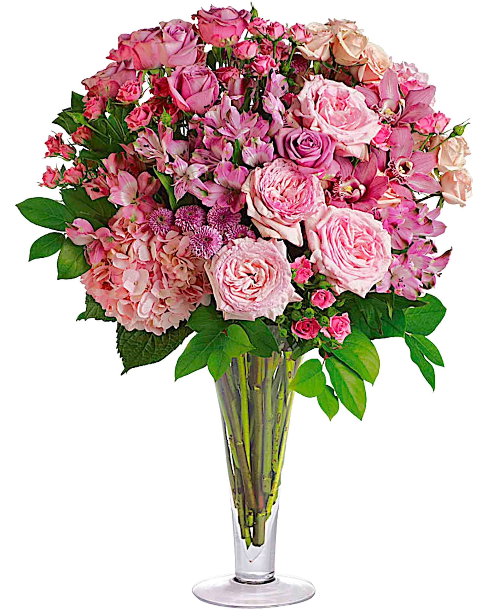 Pink rose and orchid bouquet in a clear glass vase