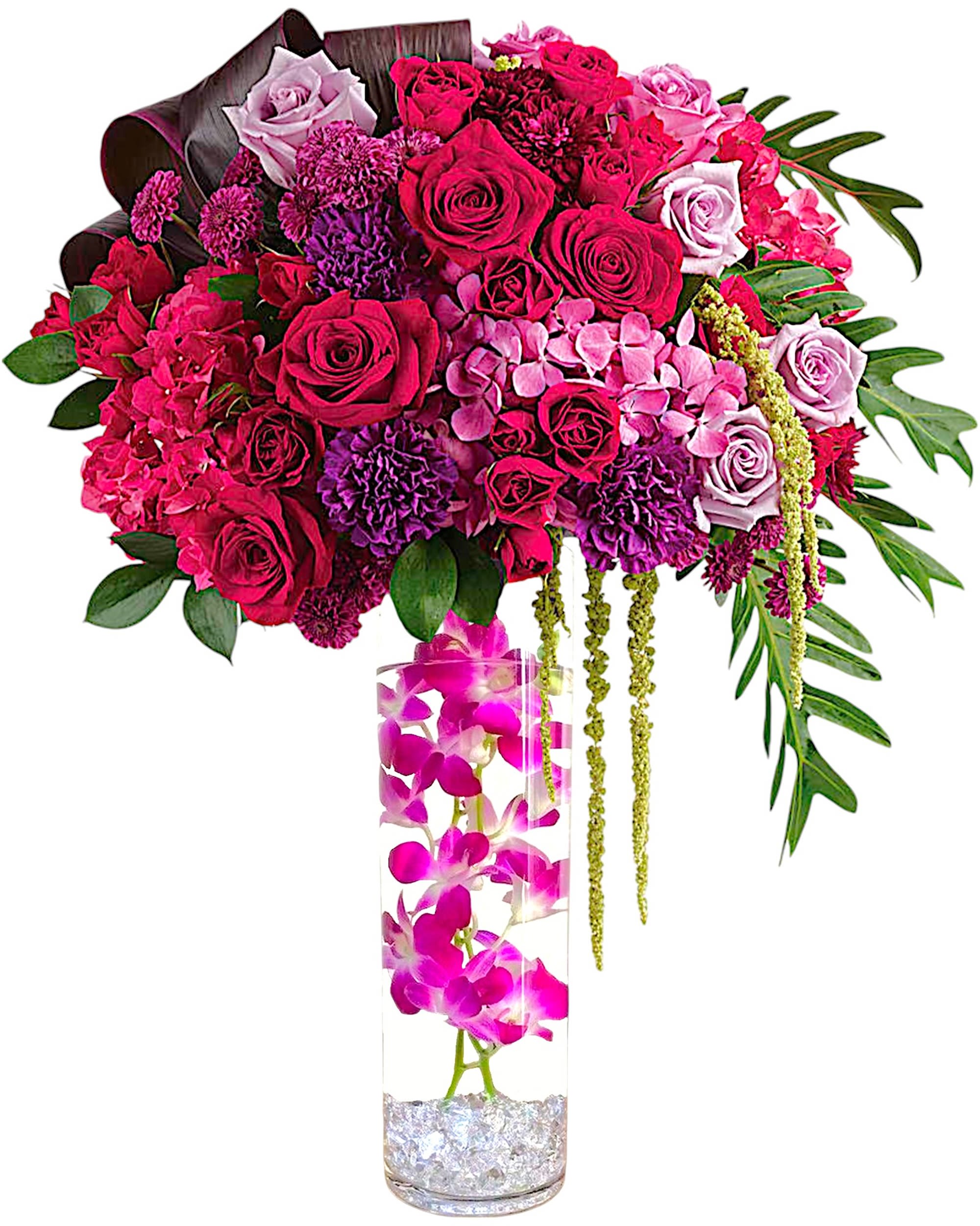 Pink and purple rose arrangement in a tall clear vase with orchids