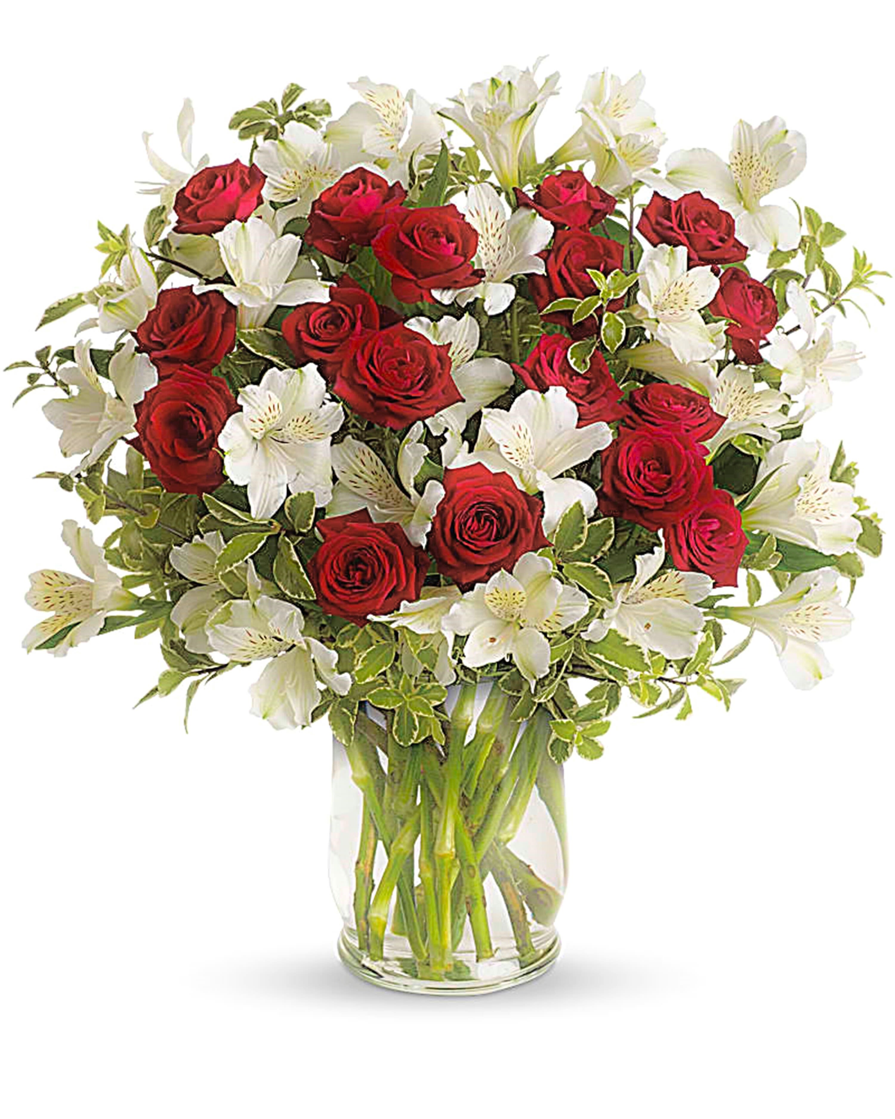 Bouquet of red roses and white alstroemeria in a clear glass vase