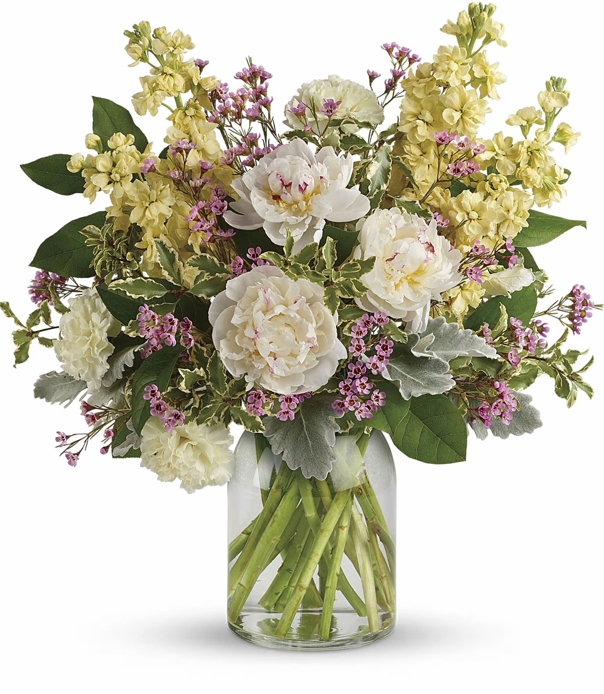 Bouquet of white peonies and yellow flowers in a clear glass vase