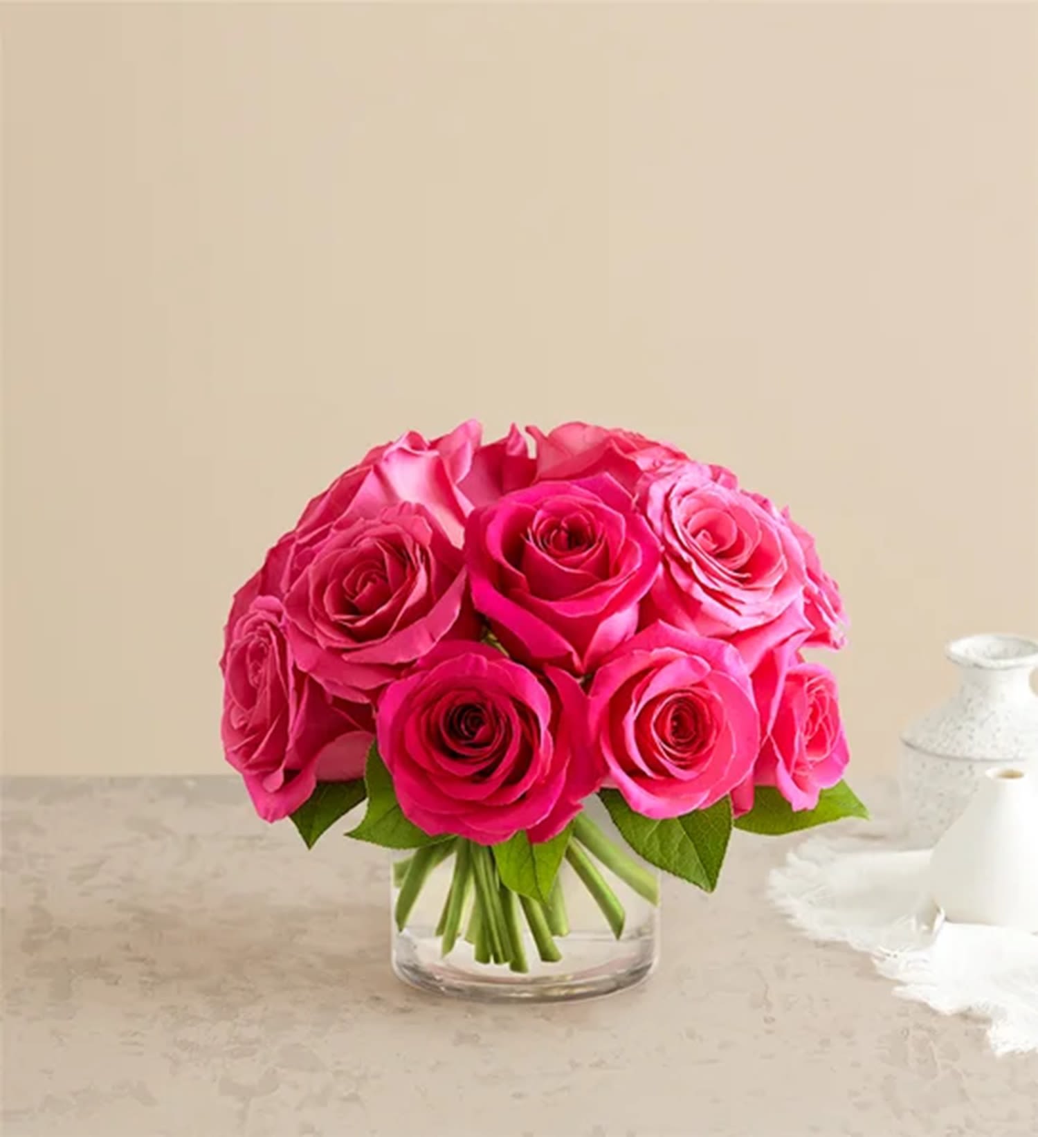 Contemporary Hot Pink Roses  - Eye-catching hot pink roses with a fun, modern vibe. Our vibrant blooms are tightly gathered into a chic dome shape with lush greenery, then hand-delivered to someone special with style and sentiment.  DETAILS Hot pink roses; accented with greenery  VASE INCLUDED Orientation: All-Around Item #NF-257  FLORIST-TO-DOOR Same day flower delivery on most orders placed online by 12 pm or 10 am on weekends PST.  BLOOM DETAILS Roses Greenery  The Standard Arrangement is approx.7" H x 7" W. One Dozen (VASE 4"H) The Deluxe Arrangement is approx. 9" H x 9" W. Two Dozen (VASE 5"H) The Premium Arrangement is approx. 11" H x 11" W. Three Dozen  How to place an order?  1. You can place an order directly on this secure website OR 2. You can call in your order by dialing: (323) 262 - 9238 OR 3. You can visit our store (appointment recommended 323.262.9238)  NINFA'S FLOWERS 2405 WHITTIER BLVD. LOS ANGELES, CA. 90023  ATTENTION: *Please note that on busy holidays, Valentine's Day, and Mother's Day, we cannot verify if the recipient received the flowers until the following day. You can verify delivery on the website after 10:00 pm, call 323.262.9238 the following day after 10:00 am, or contact the recipient directly. Thank you for your patience and understanding.  