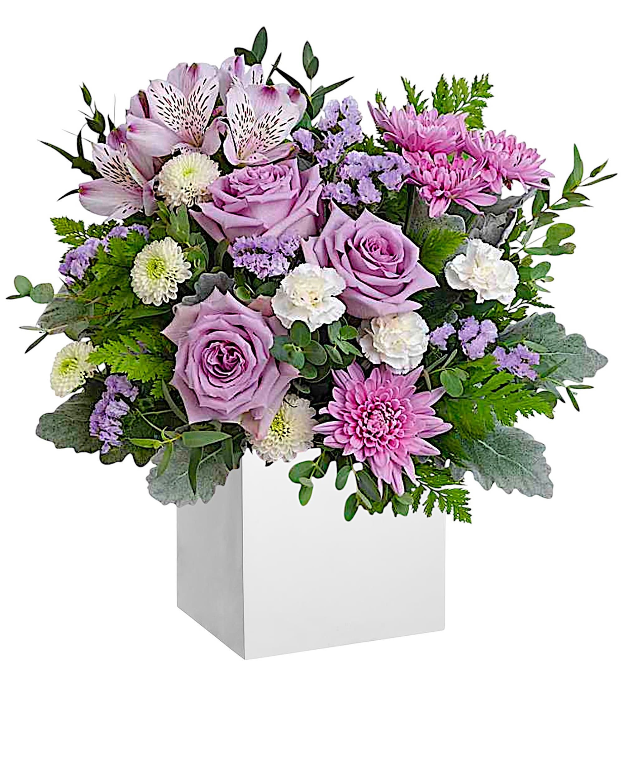 Enchanted Moments - Experience the enchantment of blooms delivered! Purple roses in a eco-friendly wooden box transform any day into something truly special.   DETAILS Experience elegance with an arrangement featuring lavender roses, alstroemeria, white carnations, white button chrysanthemums, lavender cushion chrysanthemums, lavender statice, dusty miller, leatherleaf fern, and parvifolia eucalyptus, all beautifully arranged in wooden box.  WOOD BOX INCLUDED Orientation: All-Around Item #NF-490  FLORIST-TO-DOOR Same day flower delivery on most orders placed online by 12 pm or 10 am on weekends PST.  BLOOM DETAILS Roses Button Mums Cushion Mums Alstroemerias Mini-Carnations Statice Filler Greenery  The Standard Arrangement is approx. 13 1/2" H x 13 1/4" W. The Deluxe Arrangement is approx. 13 1/2" H x 14" W. The Premium Arrangement is approx. 13 1/2" H x 14 1/2" W.  How to place an order?  1. You can place an order directly on this secure website. OR 2. You can call in your order by dialing: (323) 262 - 9238. OR 3. You can visit our store (appointment recommended 323.262.9238)  NINFA'S FLOWERS 2405 WHITTIER BLVD. LOS ANGELES, CA. 90023  ATTENTION: *Please note that on busy holidays, Valentine's Day, and Mother's Day, we cannot verify if the recipient received the flowers until the following day. You can verify delivery on the website after 10:00 pm, call 323.262.9238 the following day after 10:00 am, or contact the recipient directly. Thank you for your patience and understanding.