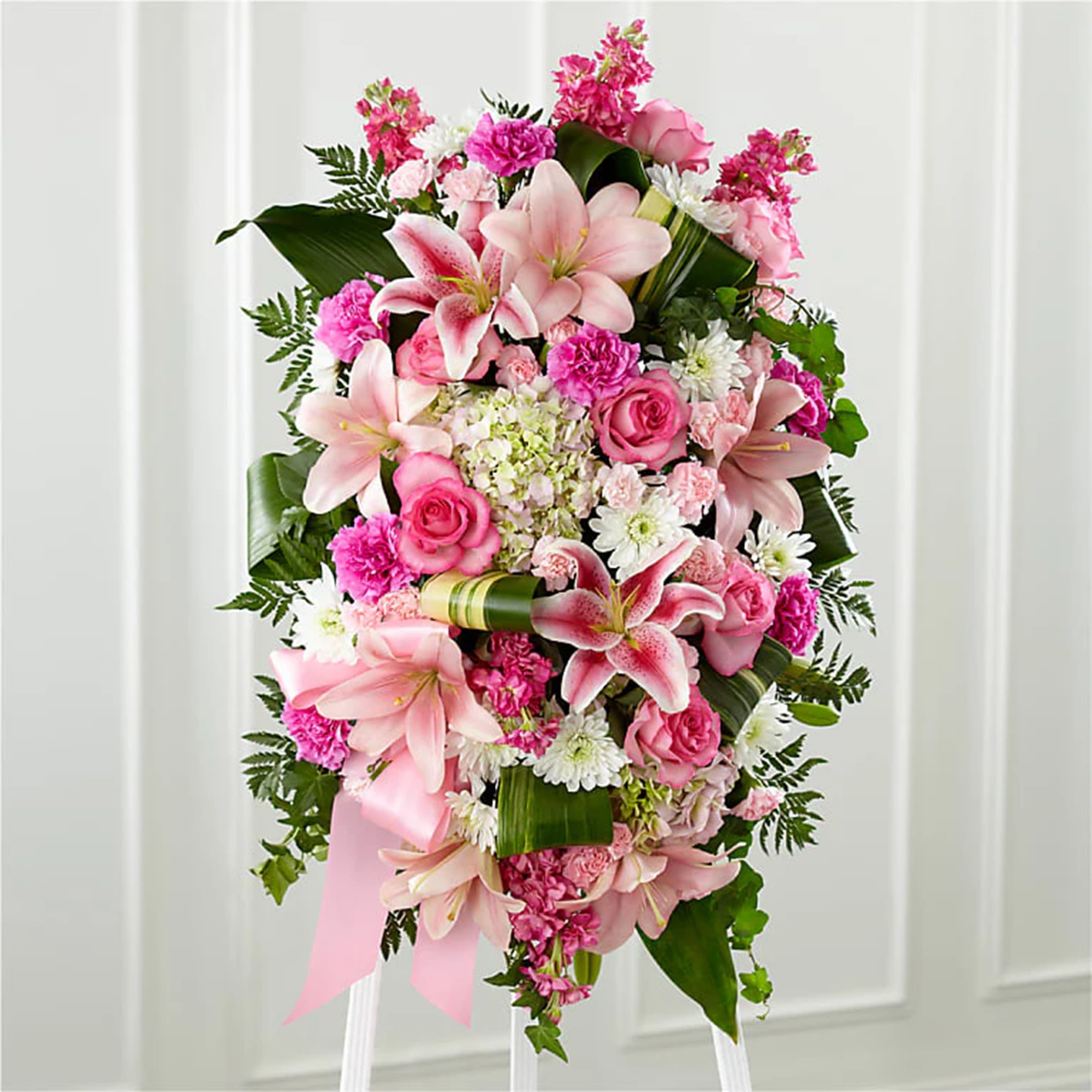 Pink and white floral standing spray with lilies and roses