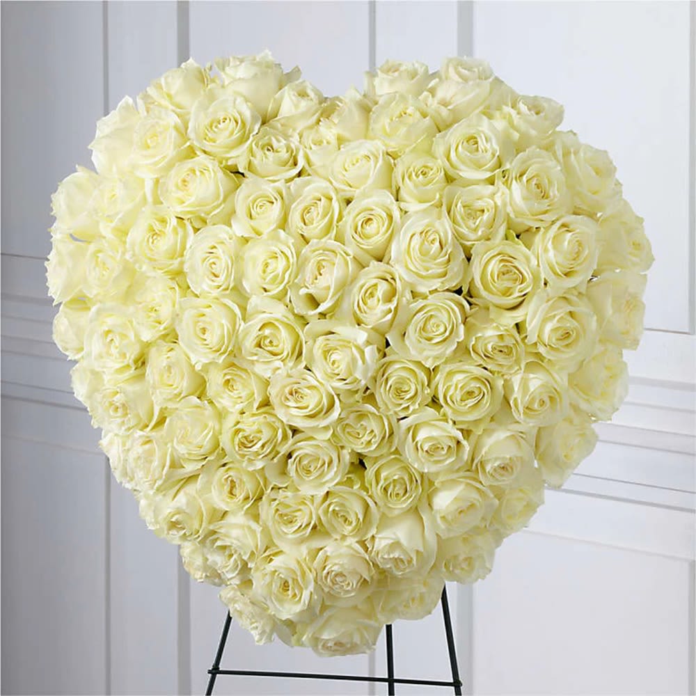 Large heart-shaped bouquet of cream roses on a stand