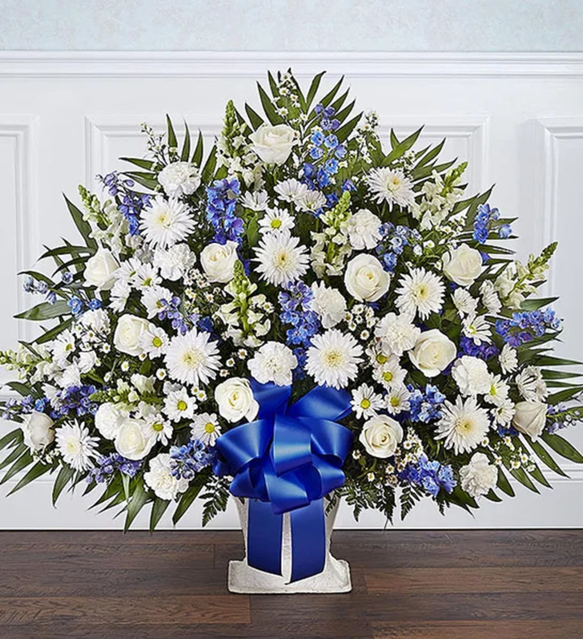 Luxury Heartfelt Tribute Blue &amp; White Floor Basket Arrangement - Offer the peace and tranquility that comes from classic blue and white flowers. The elegant floor basket arrangement, handcrafted with white and blue blooms, is a tasteful gesture perfectly suited for the funeral services, memorial service or graveside.  DETAILS Floor basket arrangement of blue delphinium; white roses, snapdragons, cremones, carnations, daisy mums and monte casino; accented with soft, lush greenery  BASKET CONTAINER INCLUDED Orientation: One-Sided Item #NF-1316  FLORIST-TO-DOOR Same day flower delivery on most orders placed online by 12 pm or 10 am on weekends PST.  BLOOM DETAILS Roses Cremones Delphinium Snapdragons Carnations Daisy-Mums Montecasino Spray Greenery  The Standard Arrangement is approx. 38"H x 43"W. The Deluxe Arrangement is approx. 40"H x 44"W. The Premium Arrangement is approx. 42"H x 45"W.  How to place an order? 1. You can place an order directly on this secure website OR 2. You can call in your order by dialing: (323) 262 - 9238 OR 3. You can visit our store (appointment recommended 323.262.9238)  NINFA'S FLOWERS 2405 WHITTIER BLVD. LOS ANGELES, CA. 90023