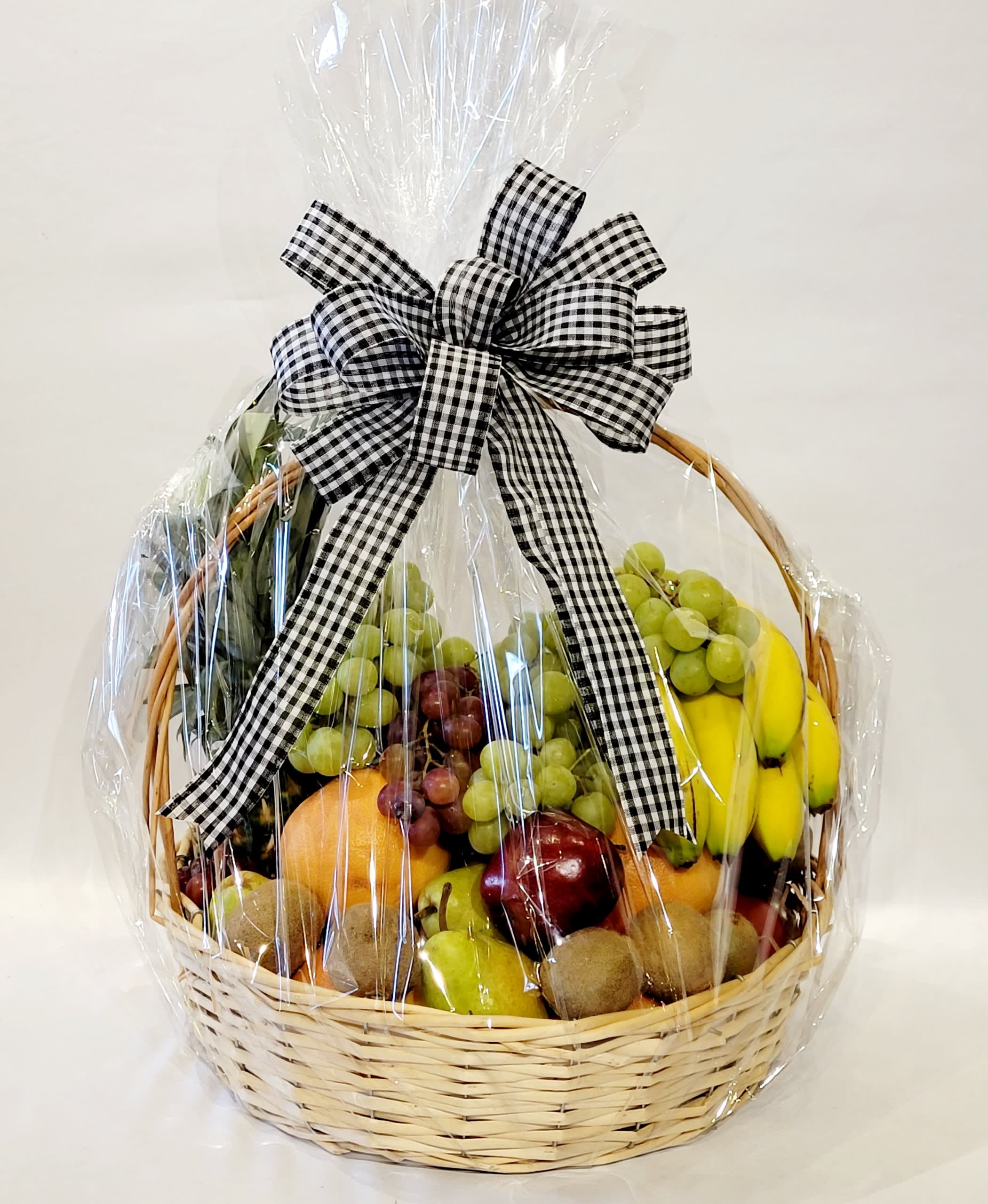 Fruit basket wrapped in cellophane with a black-and-white bow